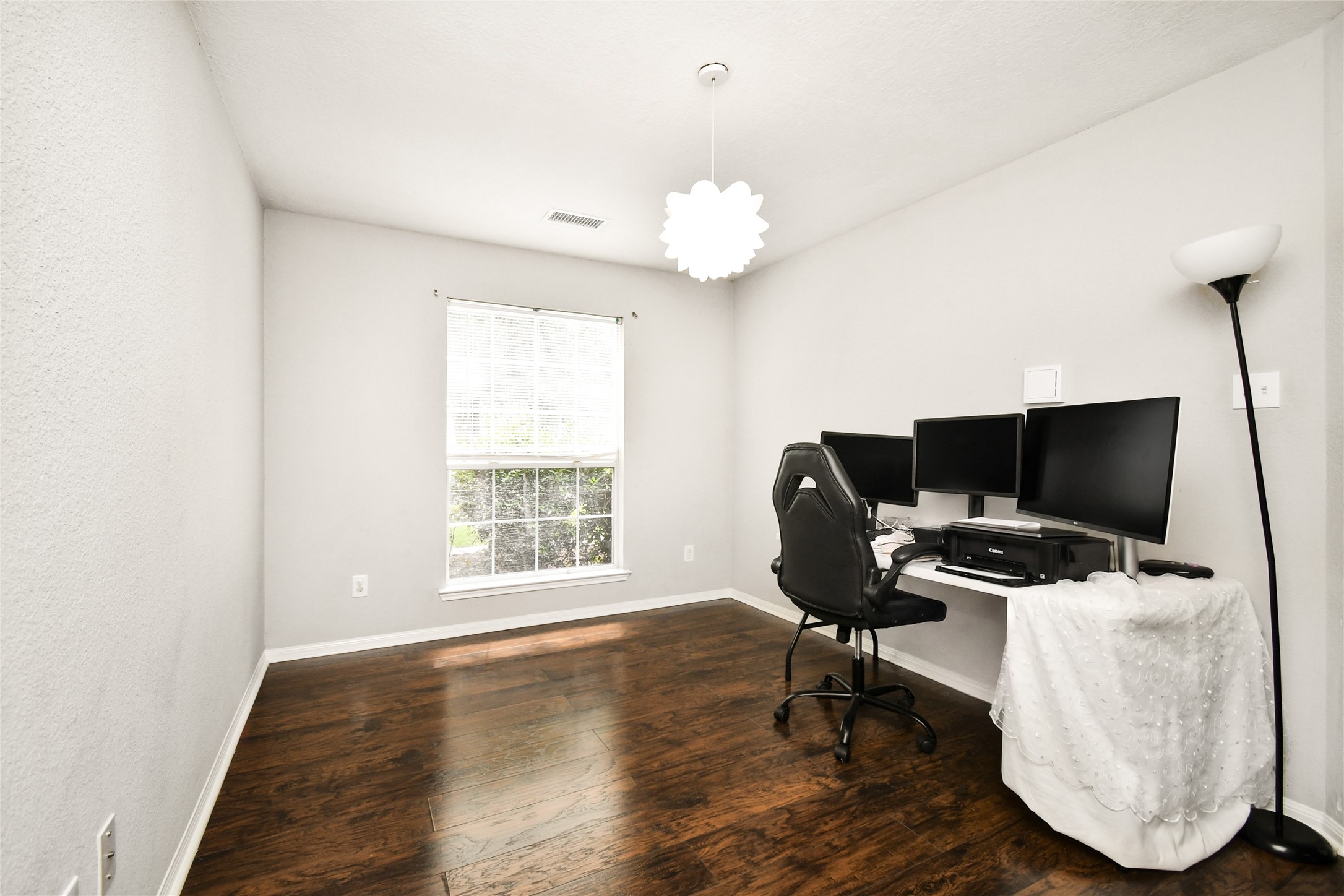 Bright flex space with a large window, perfect for a home office, playroom, or additional bedroom.