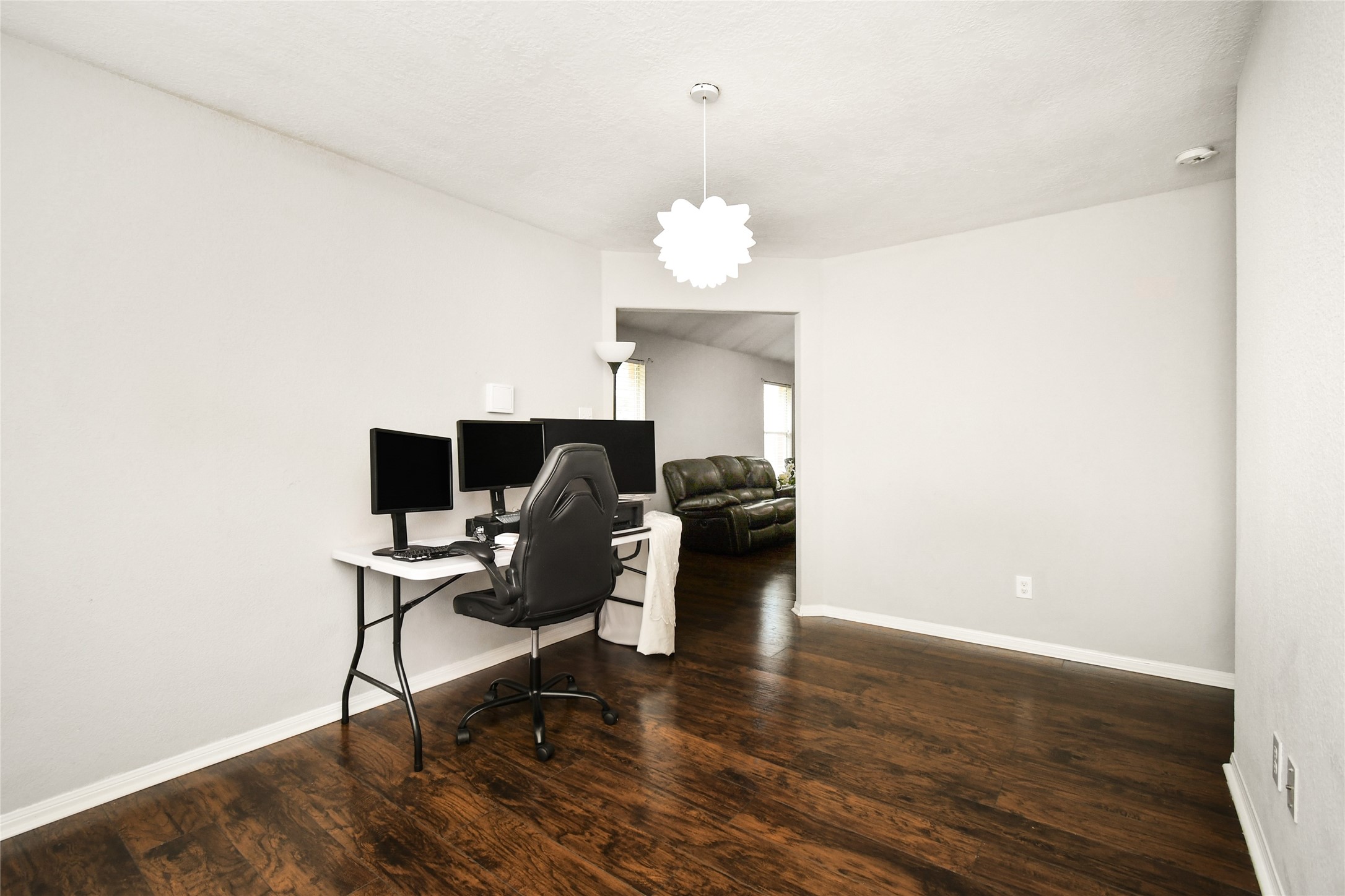 Versatile flex room currently used as a home office, offering an open view into the living area.