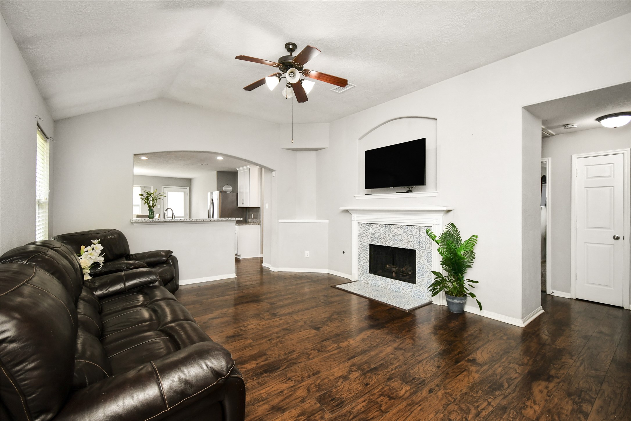 Spacious living room featuring a tile surround fireplace