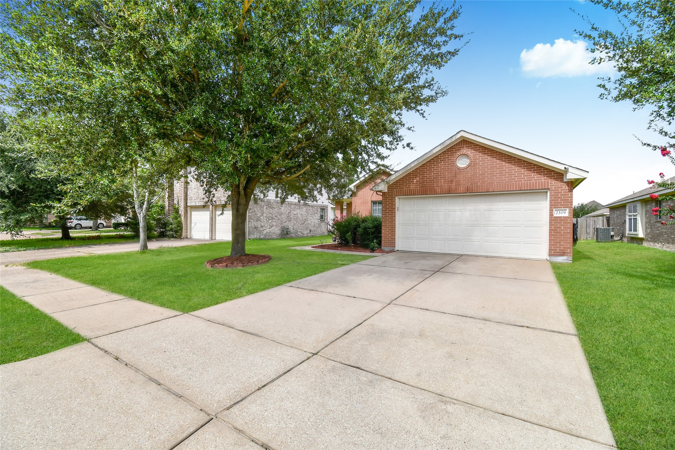 Charming brick exterior with a mature shade tree, manicured lawn, and wide driveway leading to the two car garage. Charming brick exterior with a mature shade tree, manicured lawn, and wide driveway leading to the two car garage.