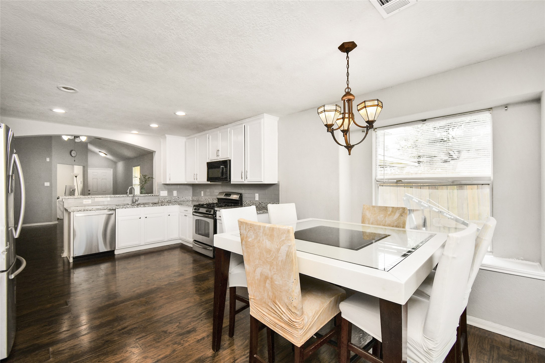 Charming breakfast nook with pendant lighting and a clear view into the fully equipped kitchen.