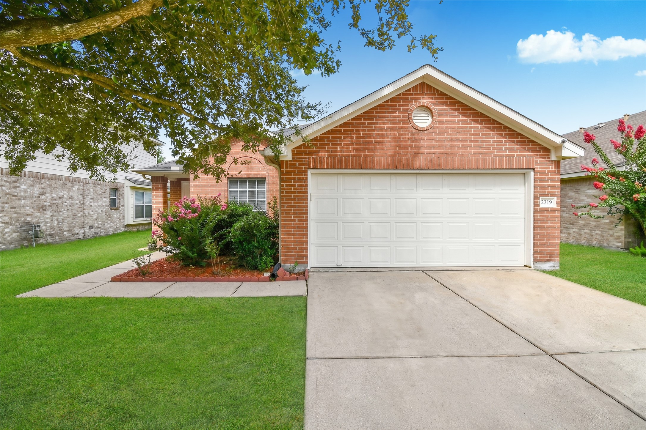 Inviting front entrance featuring classic brick detailing, an arched window, and well maintained landscaping. Inviting front entrance featuring classic brick detailing, an arched window, and well maintained landscaping.