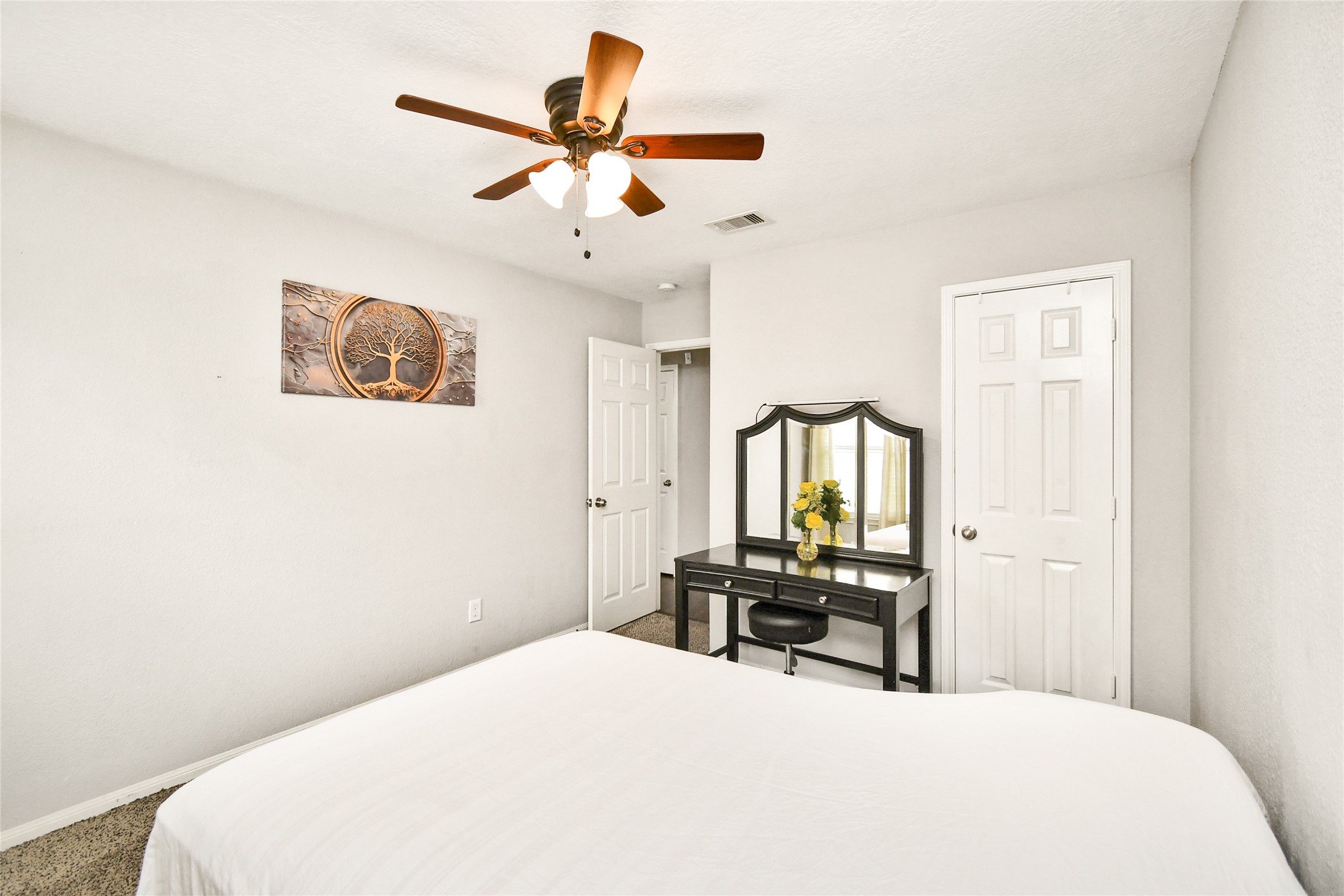 Bedroom offering generous closet space and a versatile vanity area.