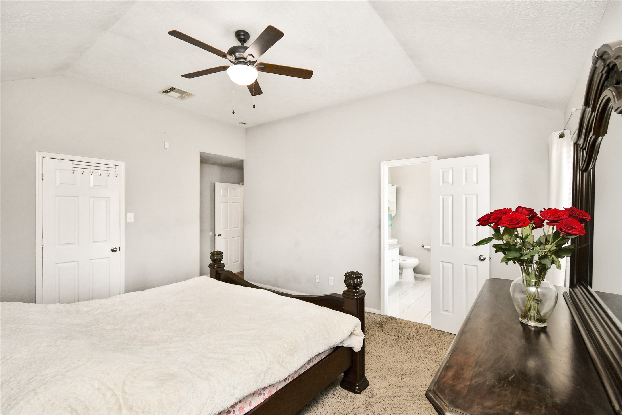 Primary bedroom offering direct access to the en suite bathroom