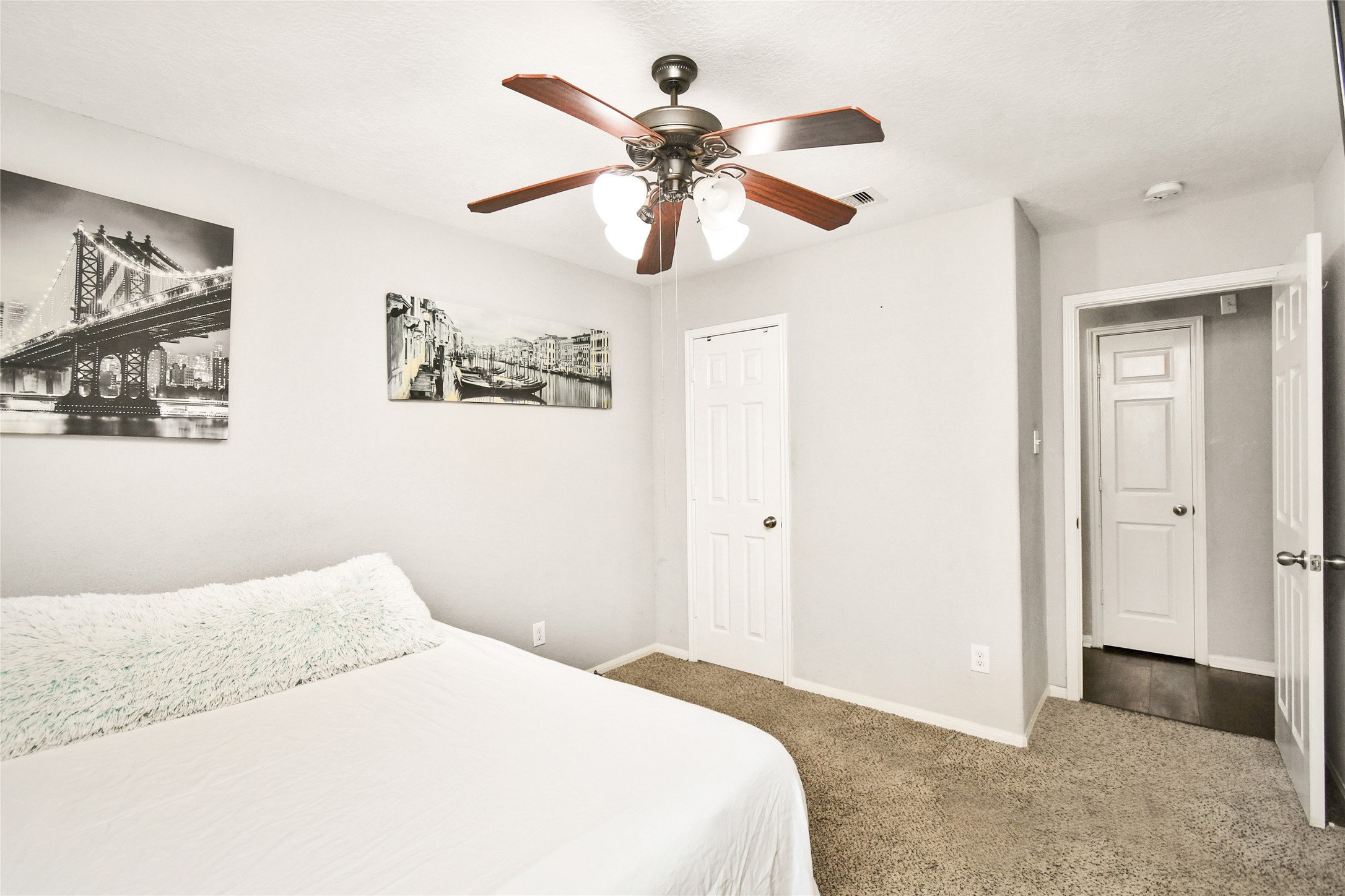 Secondary bedroom featuring a spacious closet and easy access to the hallway.