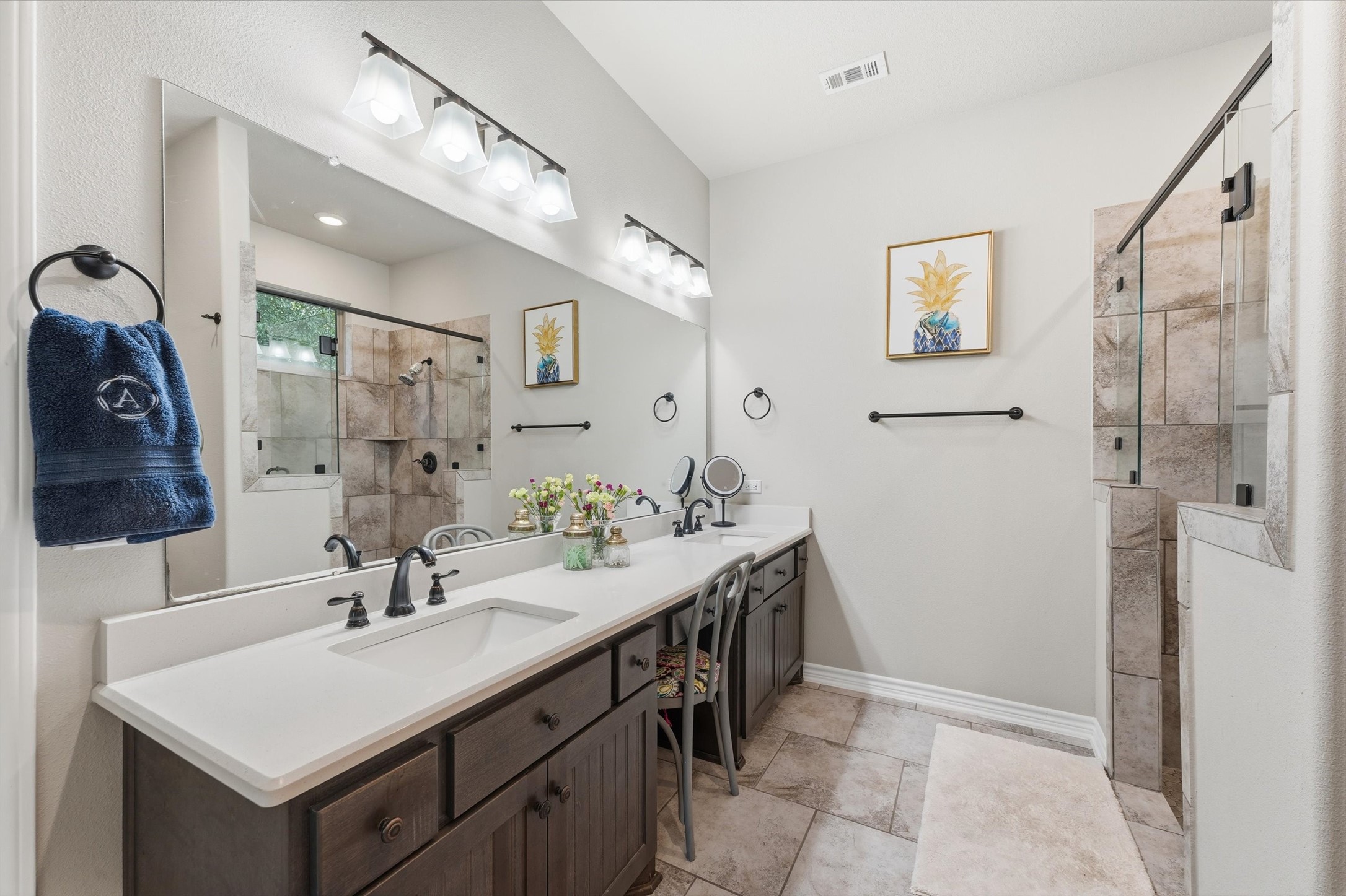 Primary bathroom has double sinks, vanity and large shower.  Big closet and shelving.