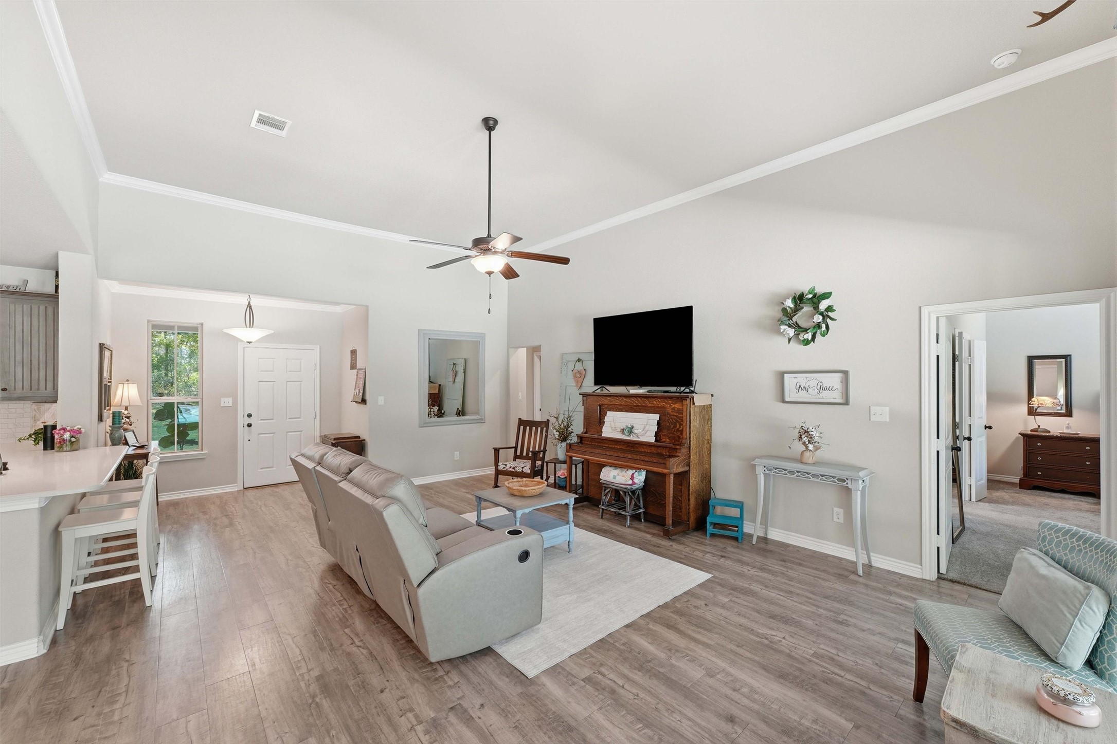 Durable and stylish flooring throughout living areas, crown molding, ceiling fans and a huge back wall for your media and furnishings.