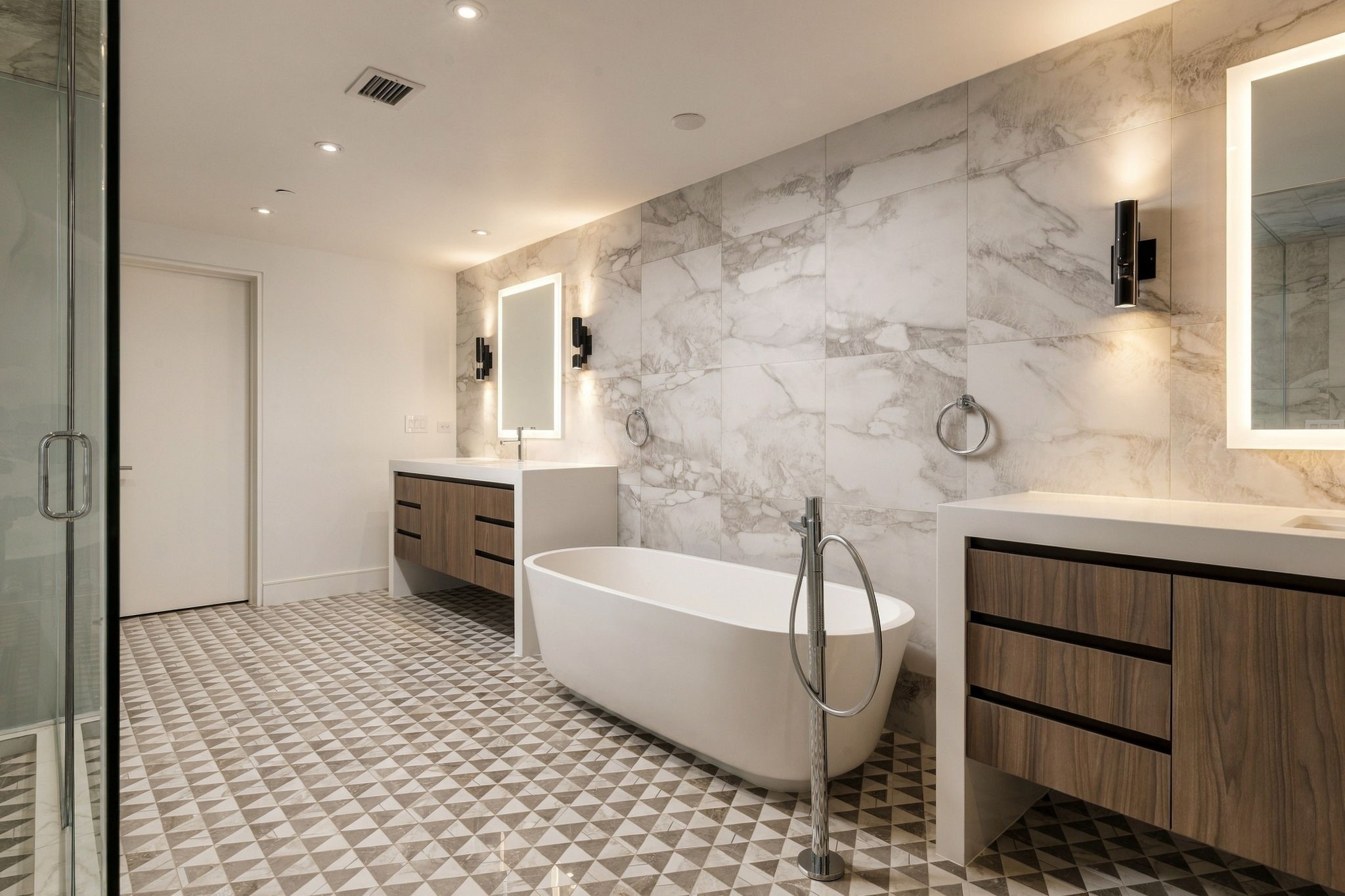 Gorgeous Italian tile, soaking tub and vanities in upstairs primary bath.   Also features two very large walk-in closets.