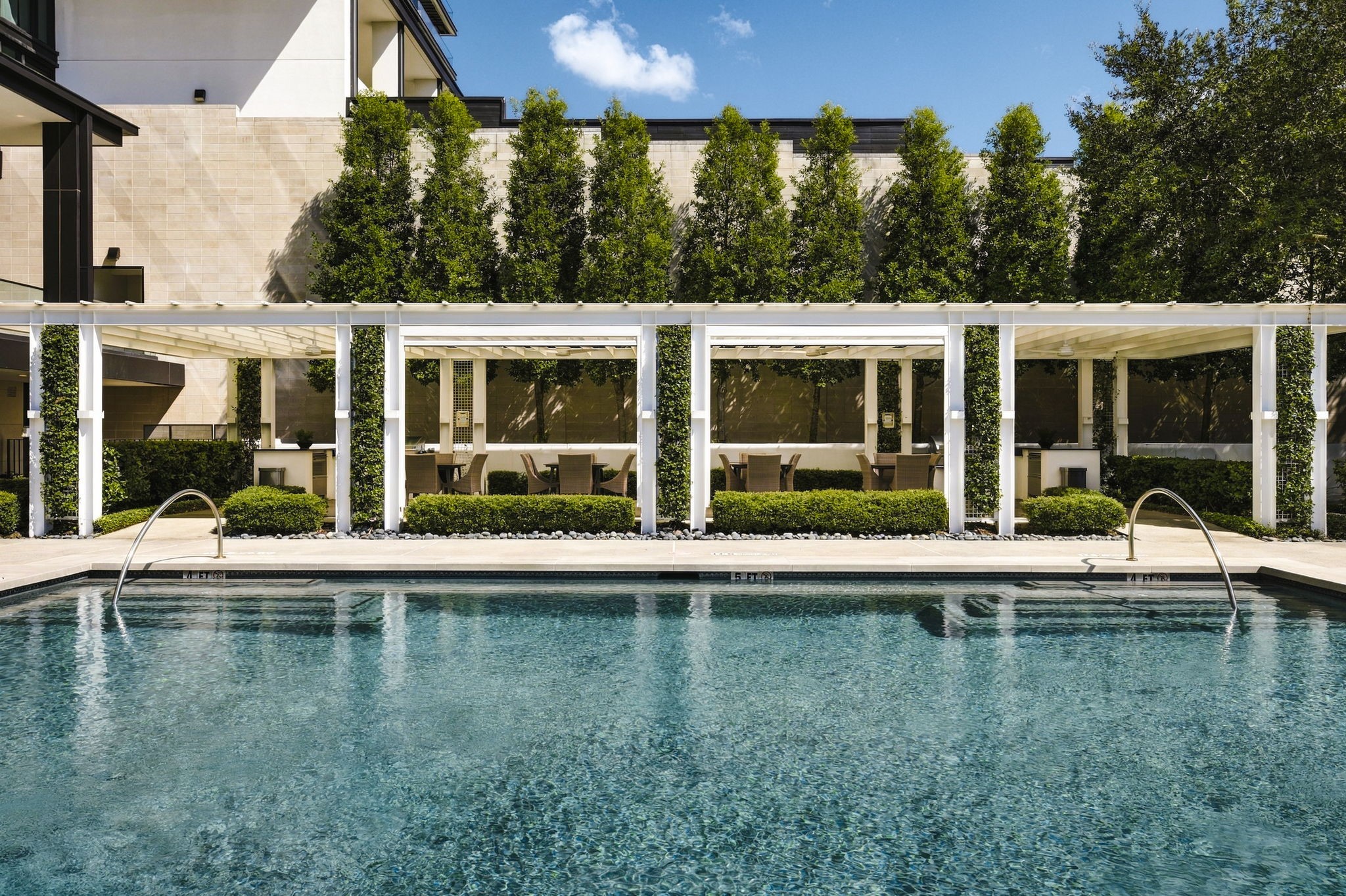 View toward dining and outdoor kitchens next to the pool.