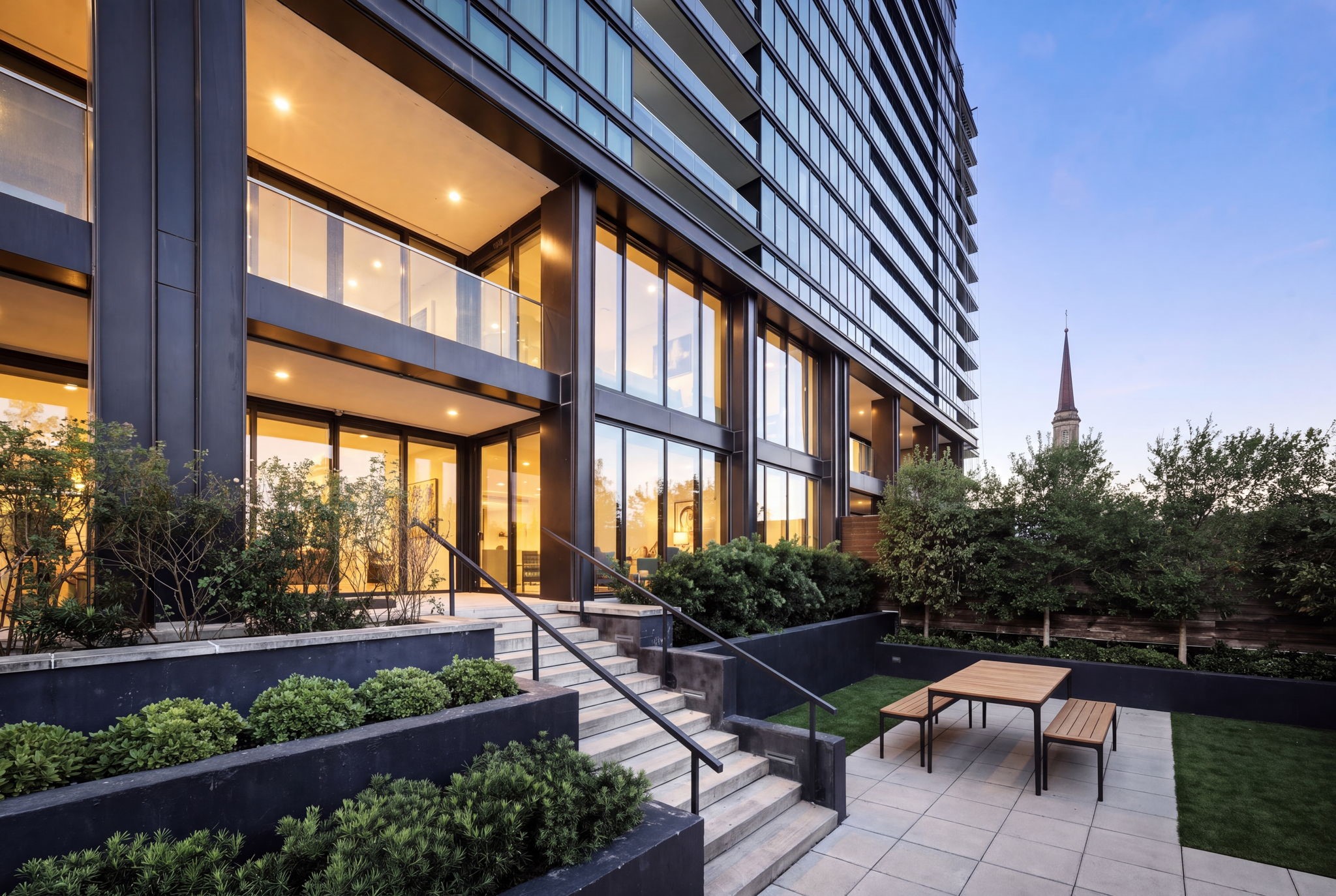 Exterior view of the home from the private garden toward steps to living room terrace.