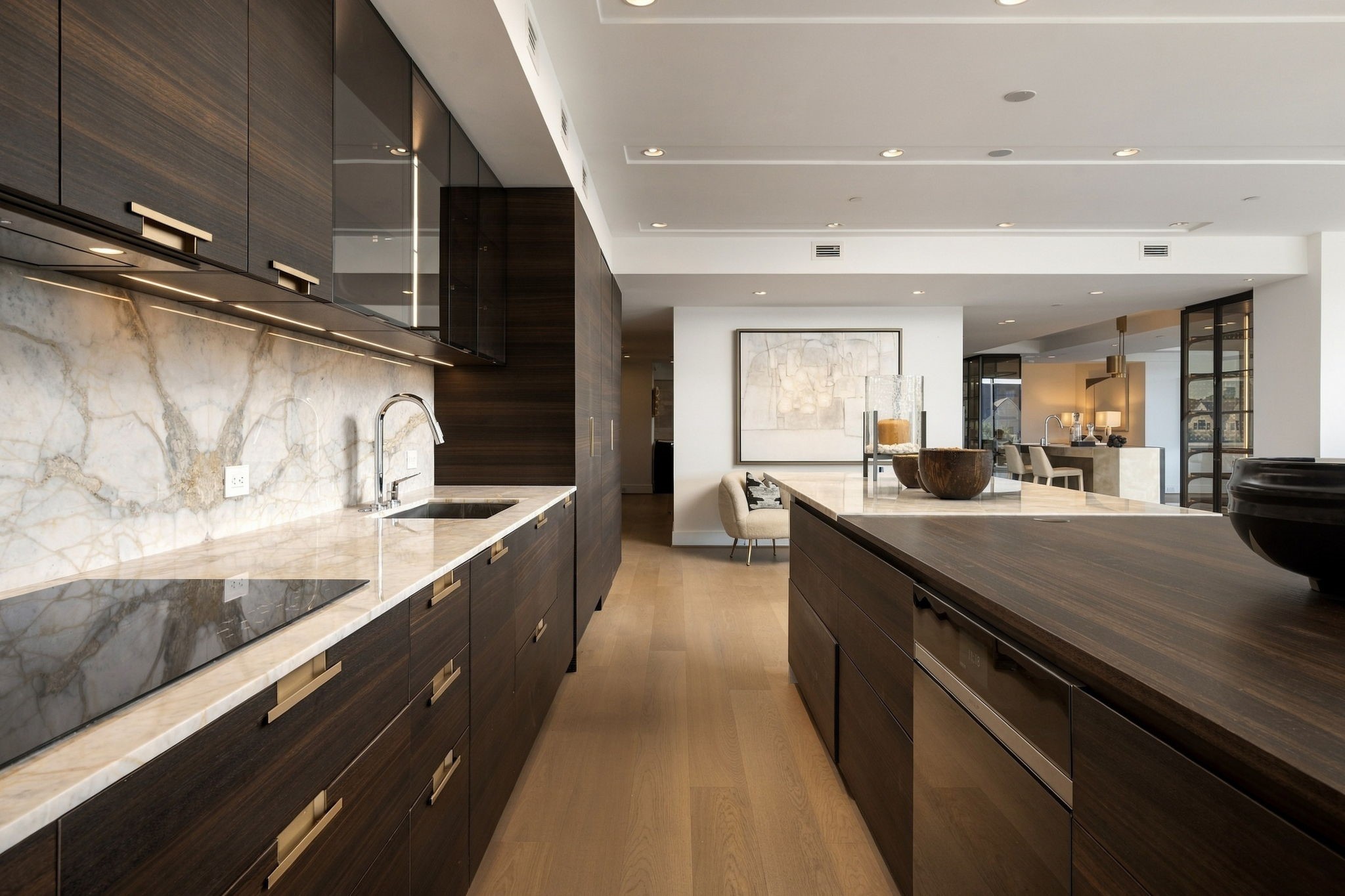 The primary kitchen's upscale appliances include a Wolf induction cooktop and wall oven, Fisher & Paykel refrigerator-freezer columns, and a Gaggenau dishwasher.