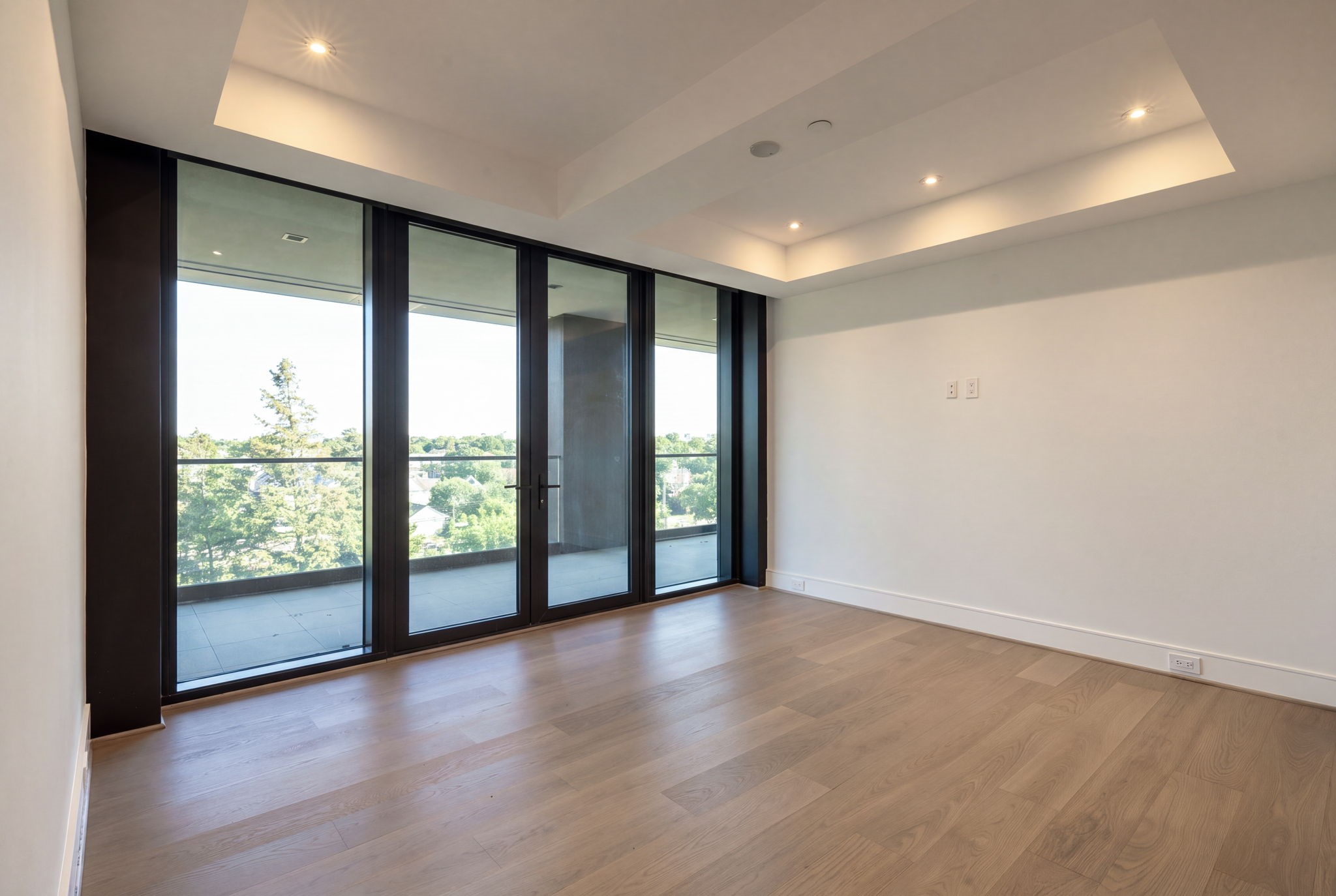 One of two secondary bedrooms upstairs shares a large terrace with another secondary bedroom, overlooking the trees of River Oaks.
