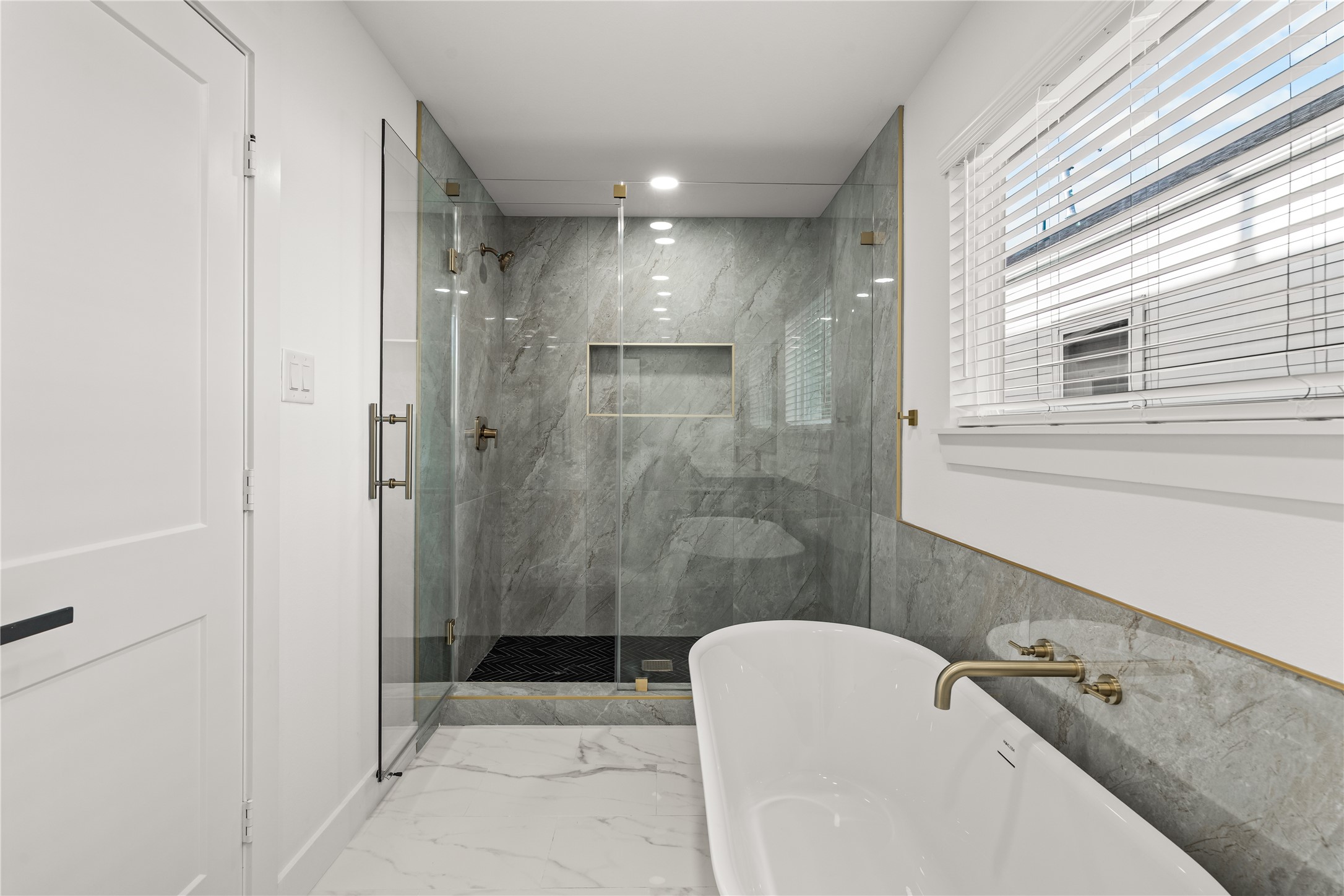 Detail-driven design. From the sleek chevron-patterned shower floor to the seamless glass enclosure, no expense was spared in crafting this sanctuary.