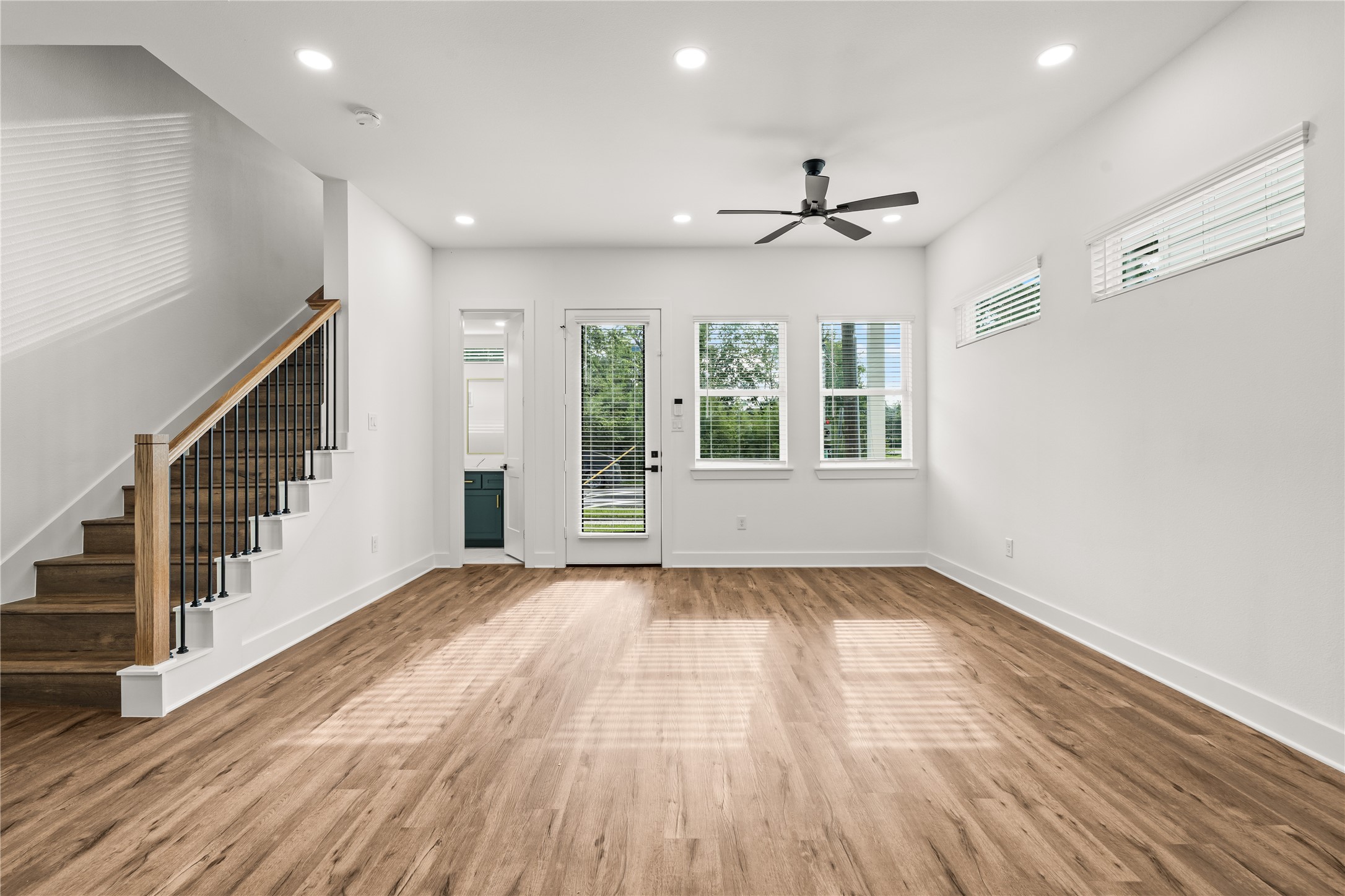 Architectural elegance on display. The modern staircase with sleek iron spindles serves as a beautiful backdrop to your main living zone.