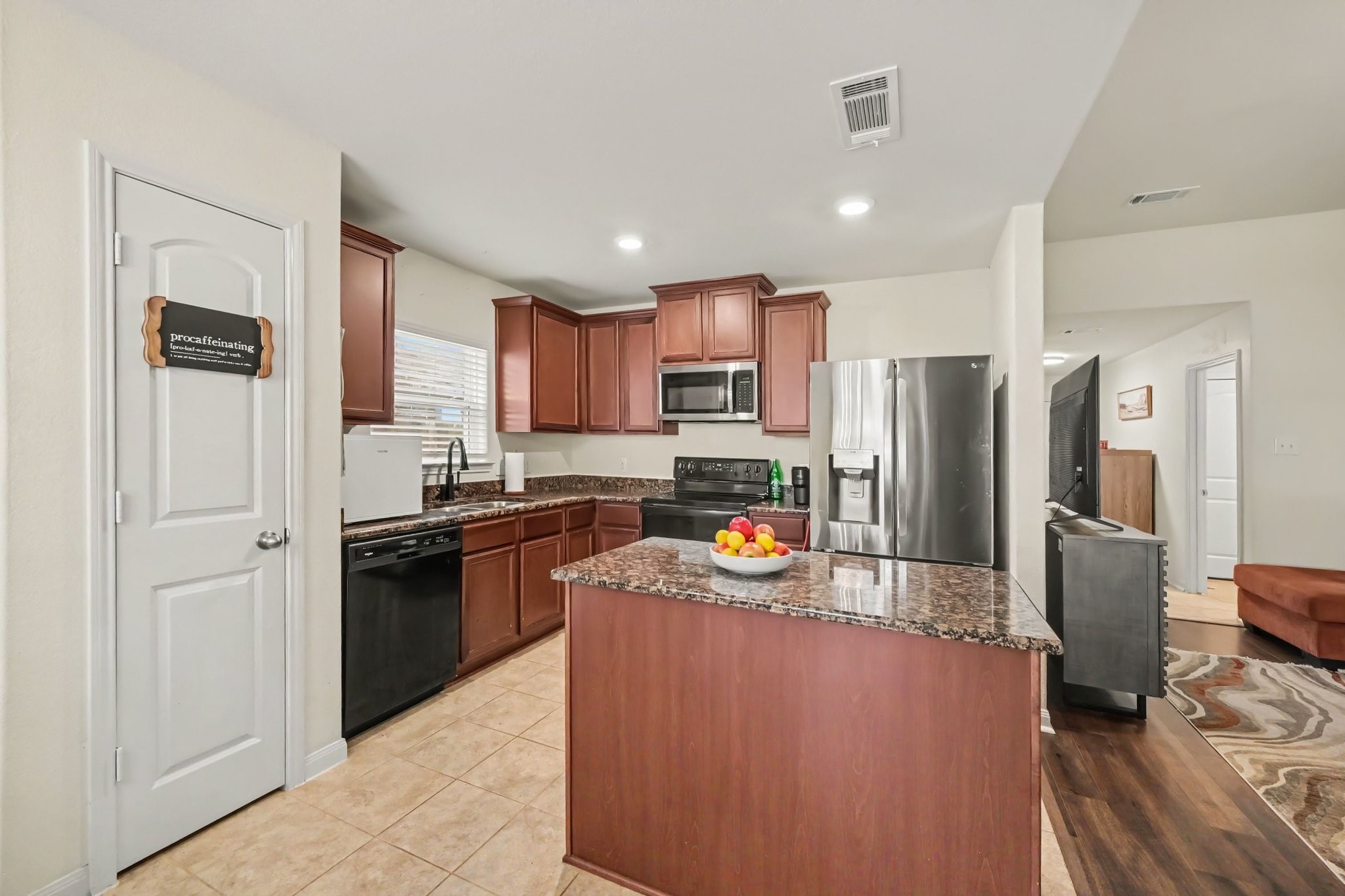 Open-concept kitchen flows seamlessly into the family room