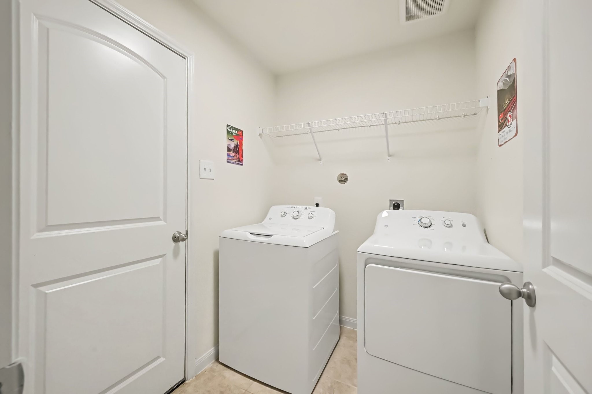 Functional utility room featuring durable ceramic tile flooring