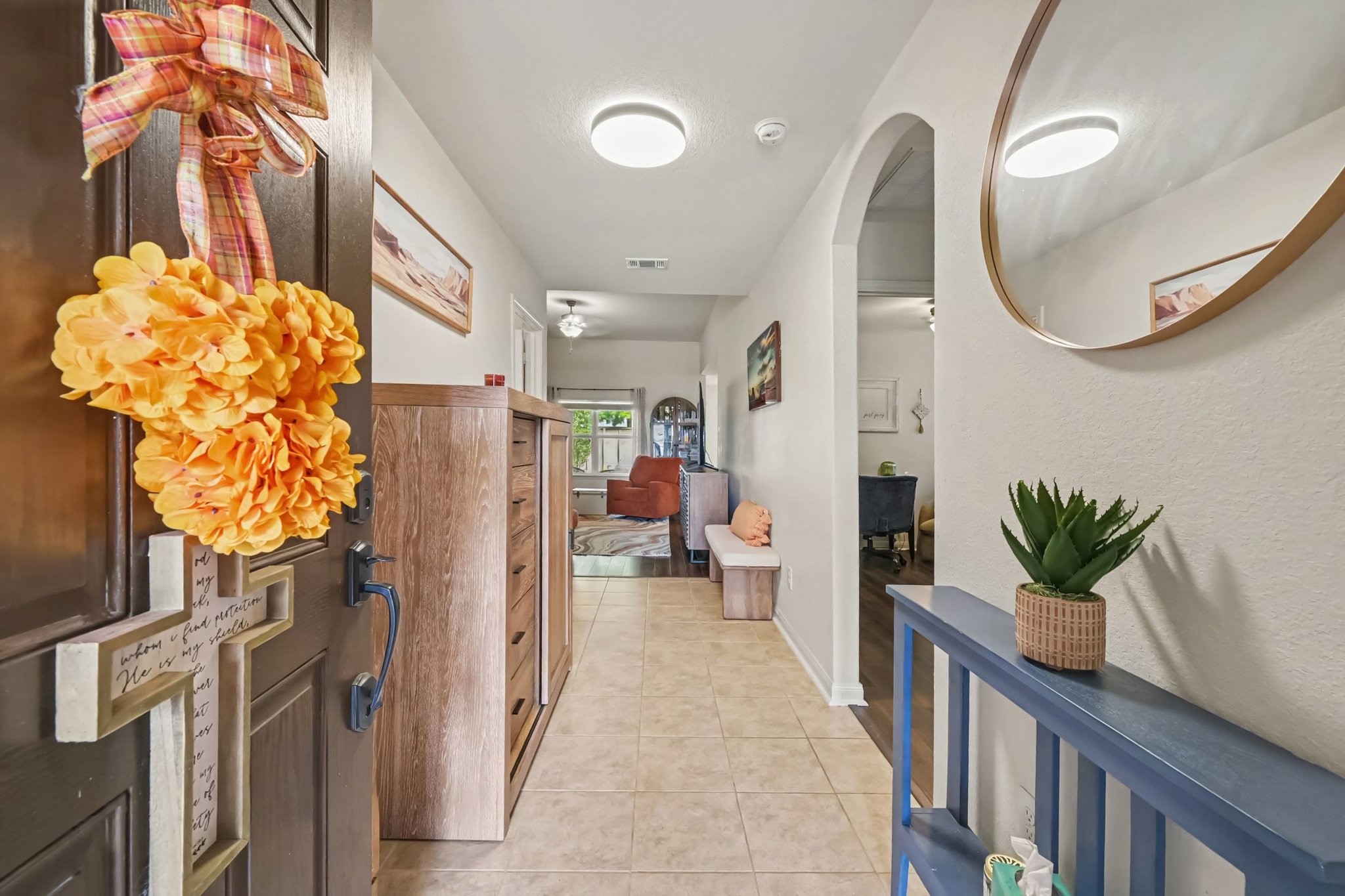 Bright entryway featuring durable ceramic tile flooring