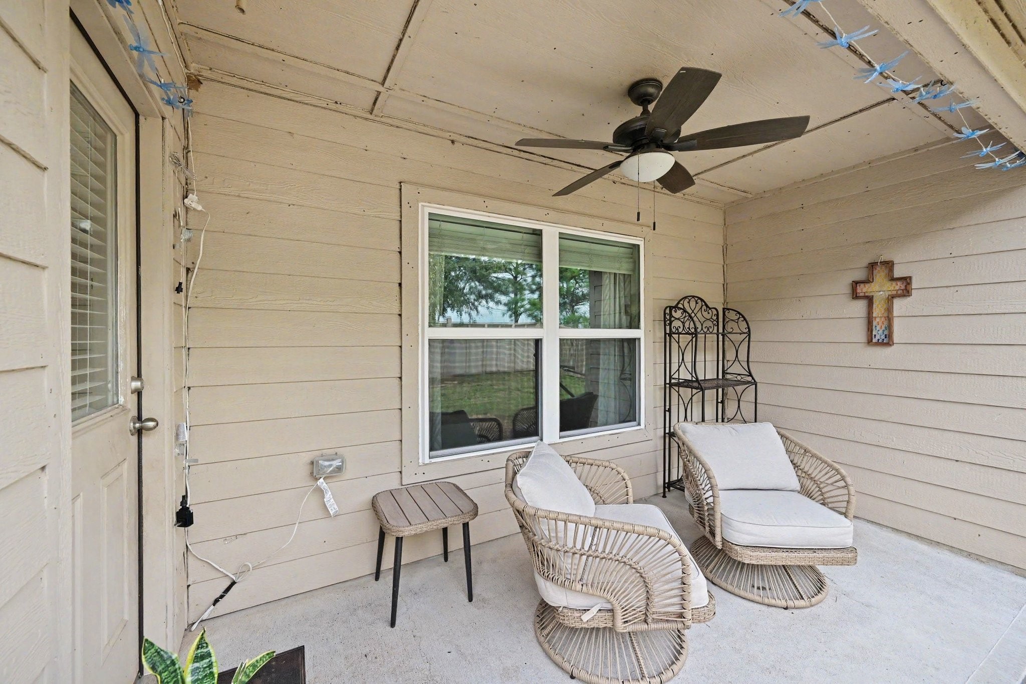 Relaxing covered patio featuring a ceiling fan for year-round comfort