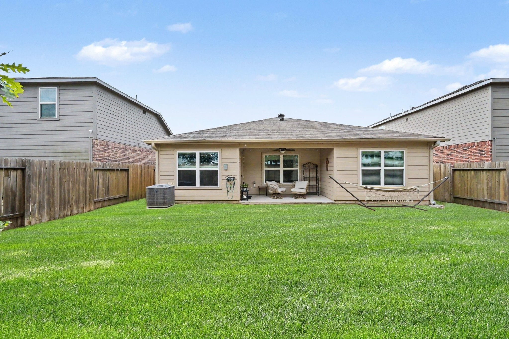 Rear view of the home showcasing the spacious backyard