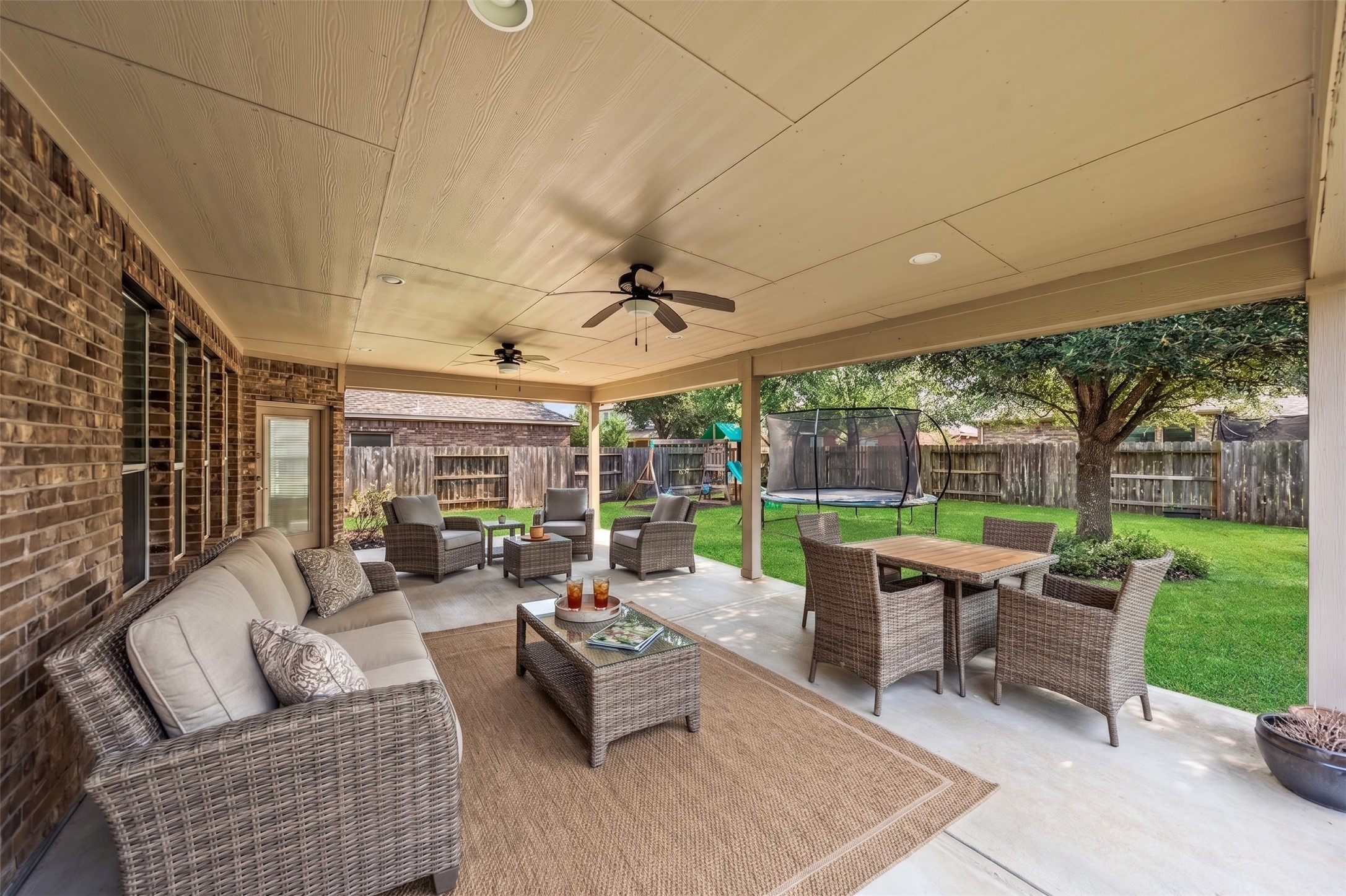 The covered patio is huge and faces east for loads of shade!  Virtually staged photo.