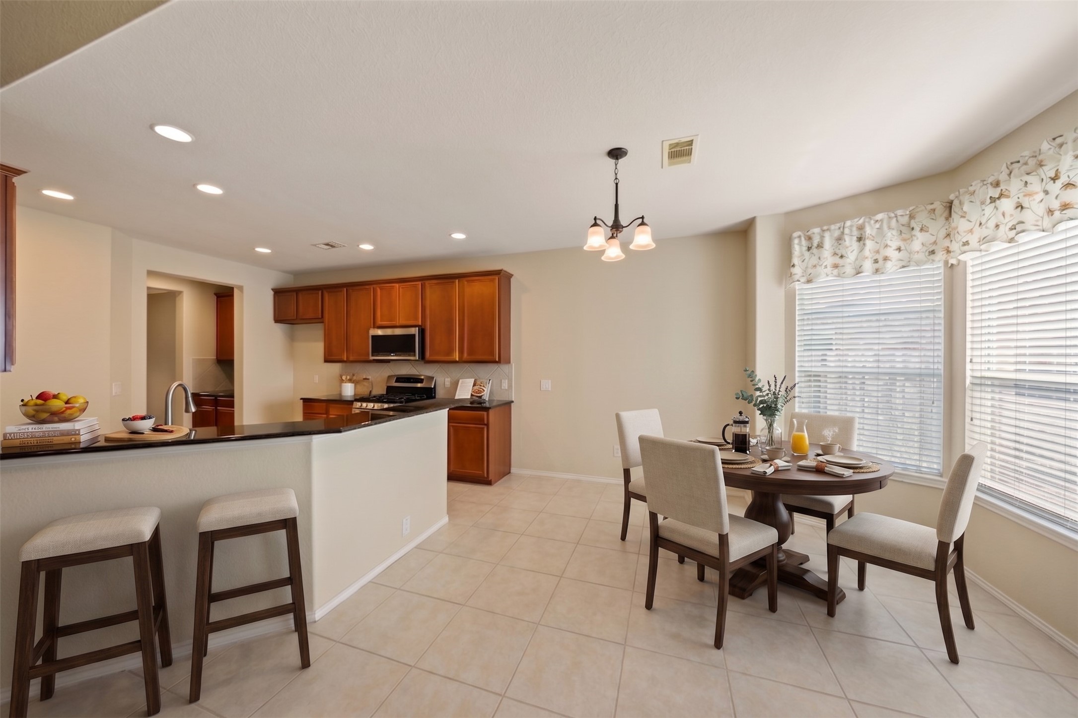 A large breakfast and bar area expands your dining space.  Virtually staged photo.