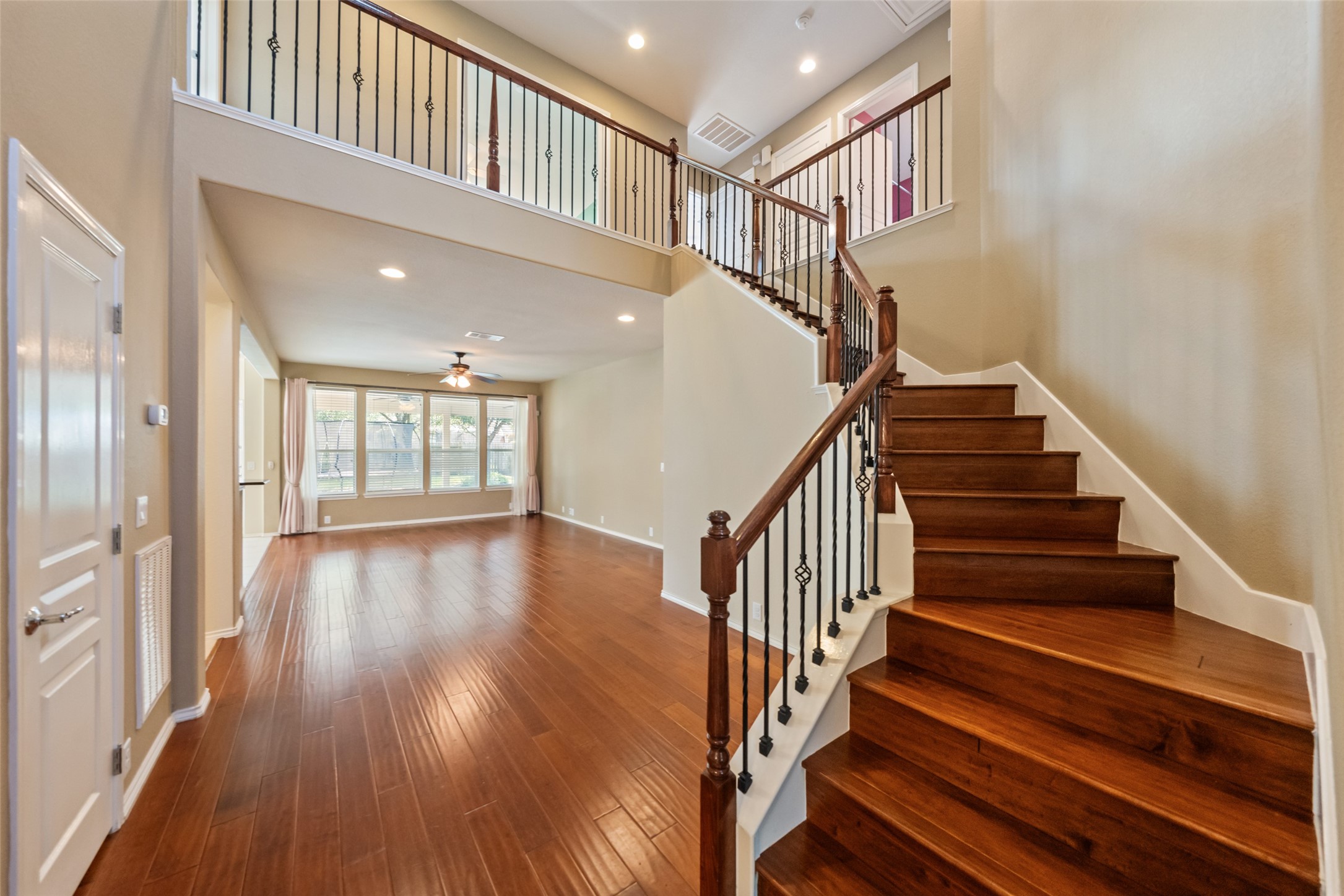 Follow the gorgeous wood floor stairs to see the other bedrooms and game room -