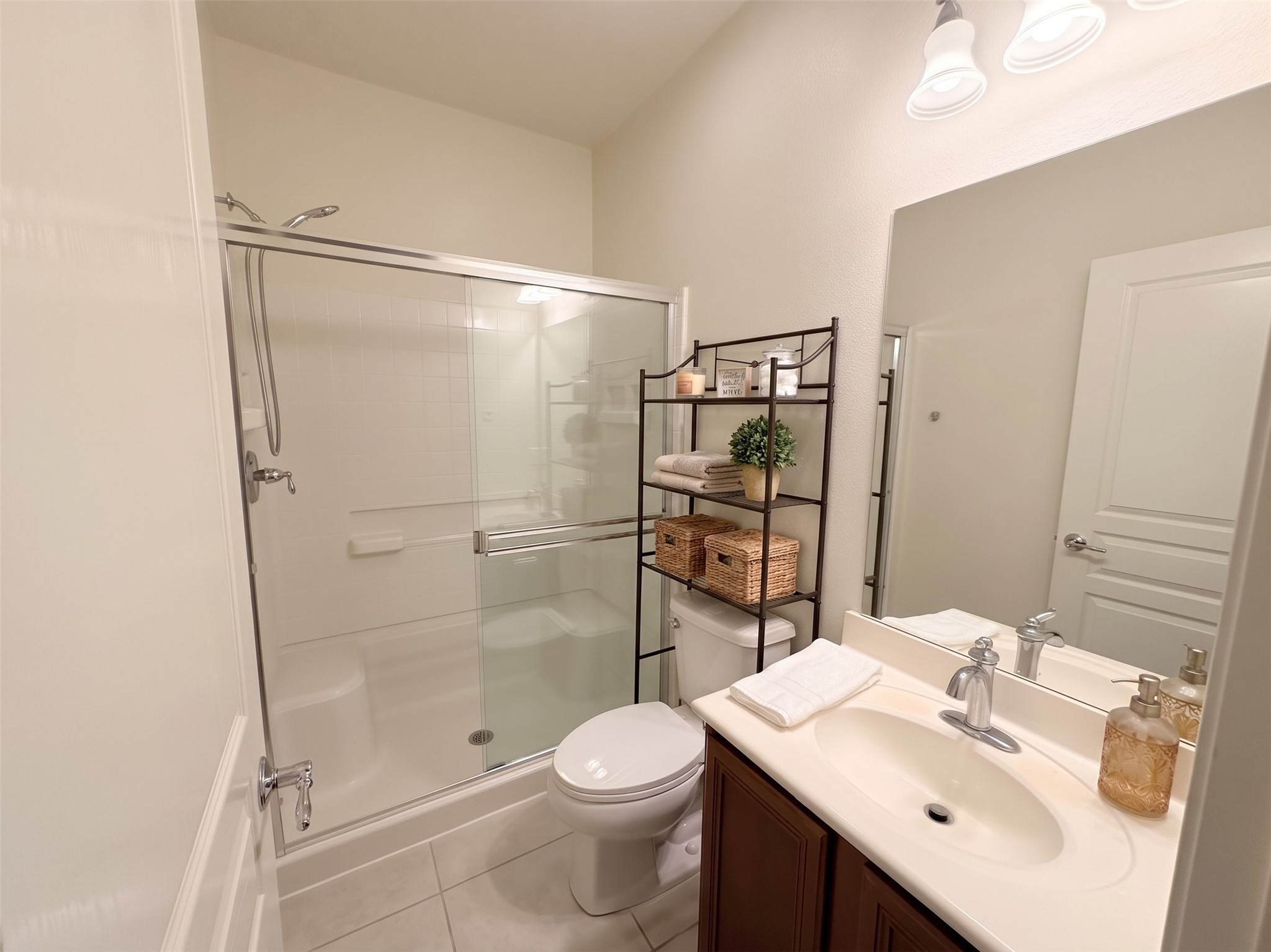 This full bath downstairs is convenient to the home office/bedroom downstairs.  Virtually staged photo.  Freshly painted.