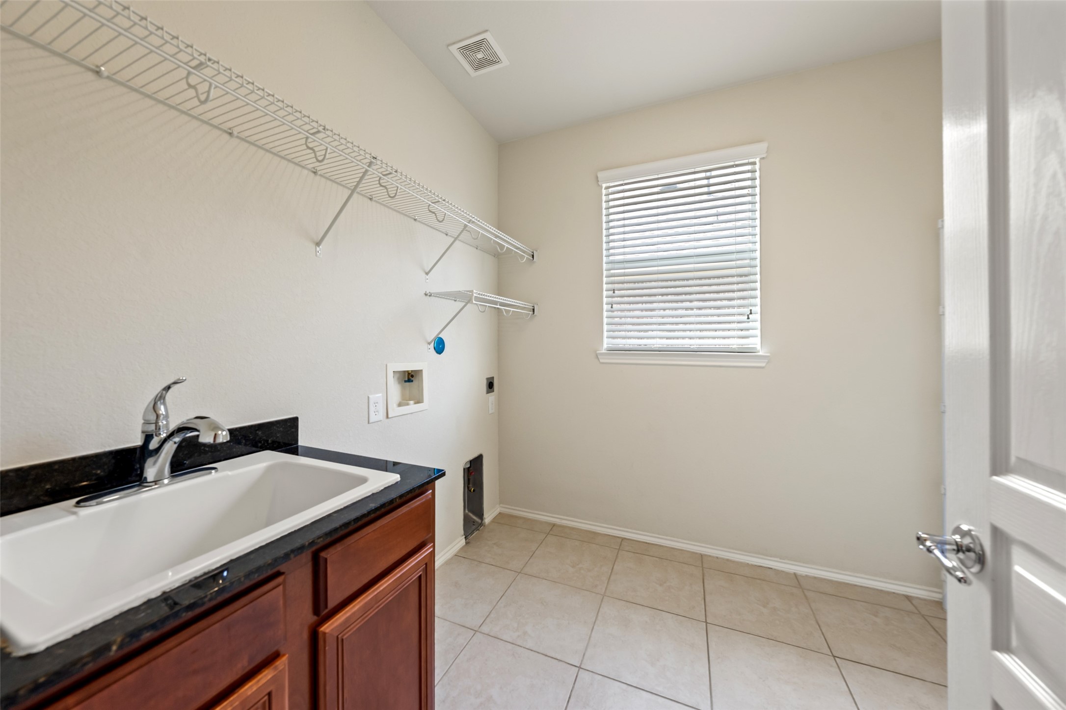 The utility room has space for an additional refrigerator and a convenient sink set up.