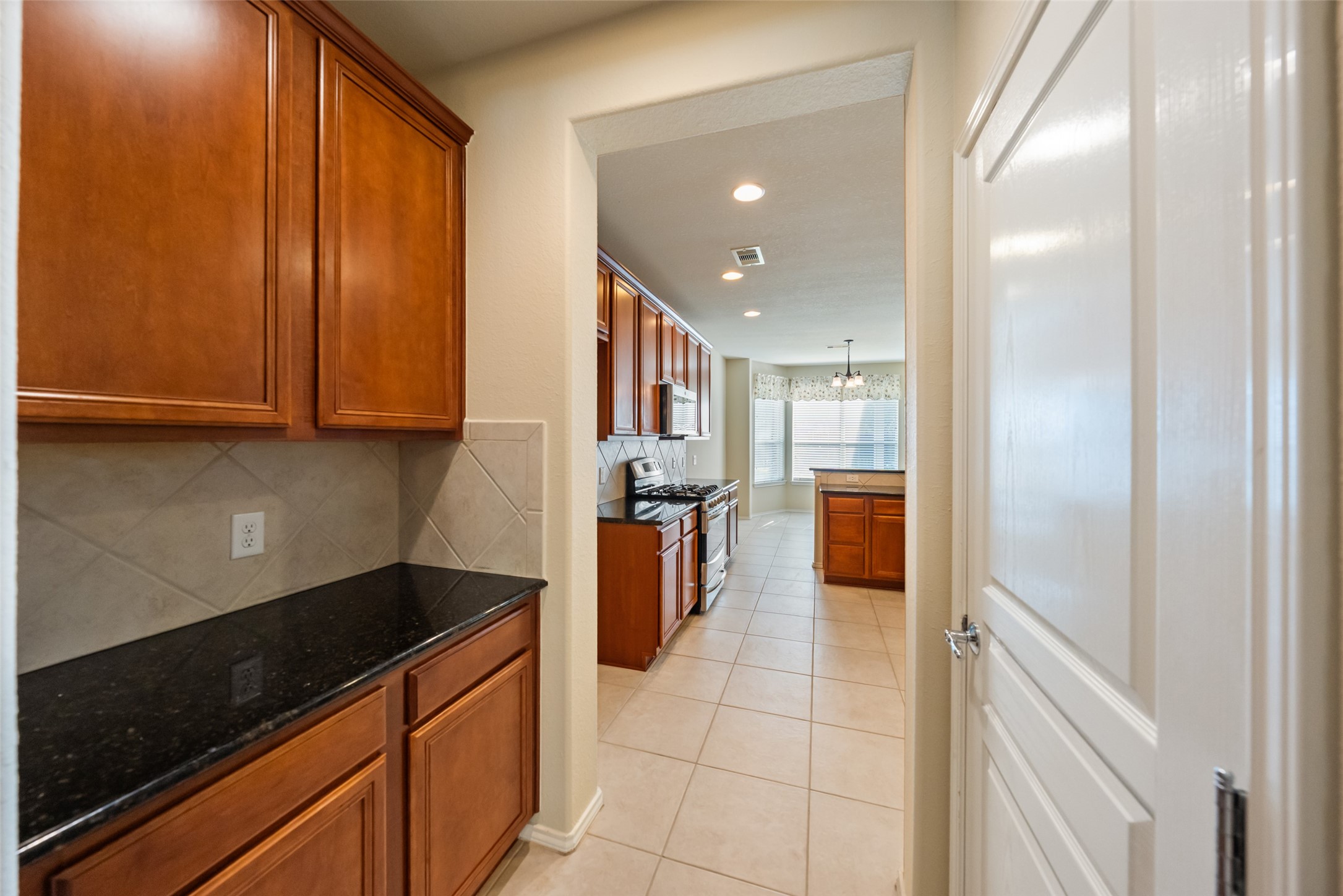 A butlers pantry is conveniently located for extra storage space.