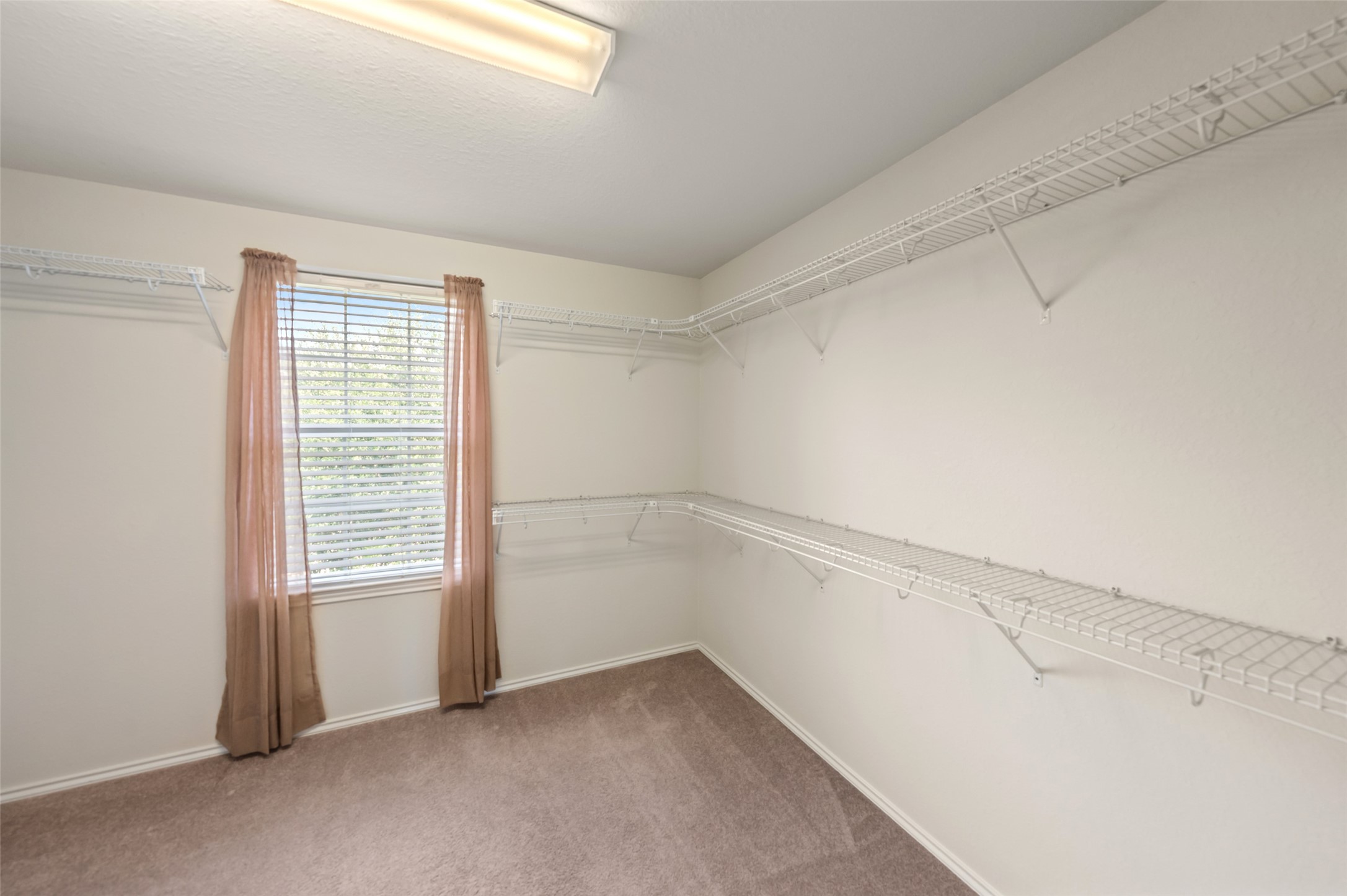 The walk in closet has all your storage needs covered.