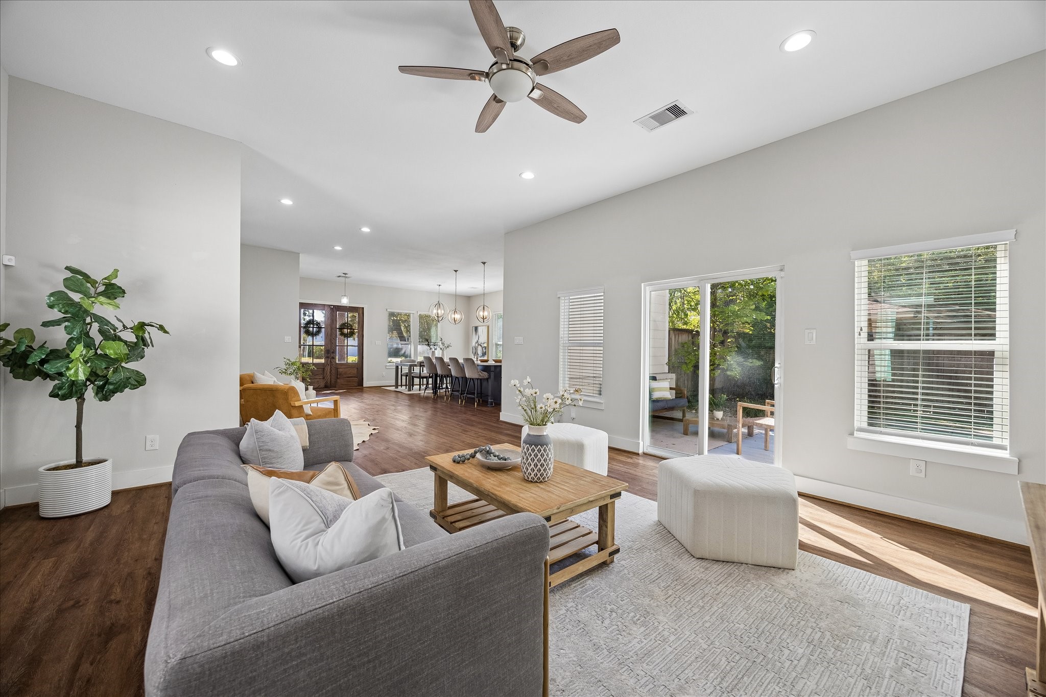 This inviting living area opens to the kitchen, den and dining room, making it easy to keep the conversation going. Large windows and sliding glass doors to the private patio welcome plenty of natural light and make outdoor entertaining a breeze.