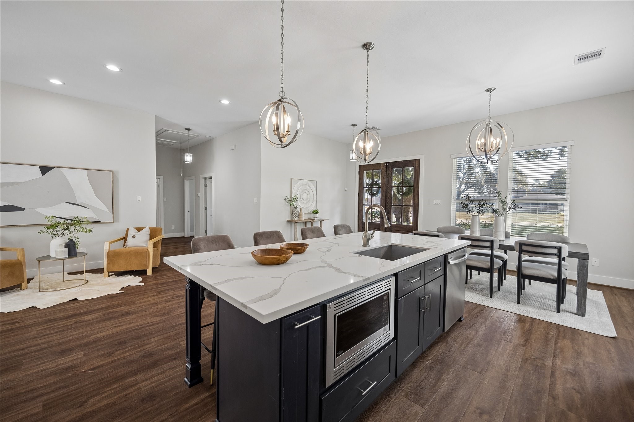 There's no shortage of workspace here! The oversized island offers additional prep and serving space, convenient bar seating, a prep sink and built-in microwave. Stylish pendant lights complete the look, while the open layout keeps the dining and living areas just steps away.