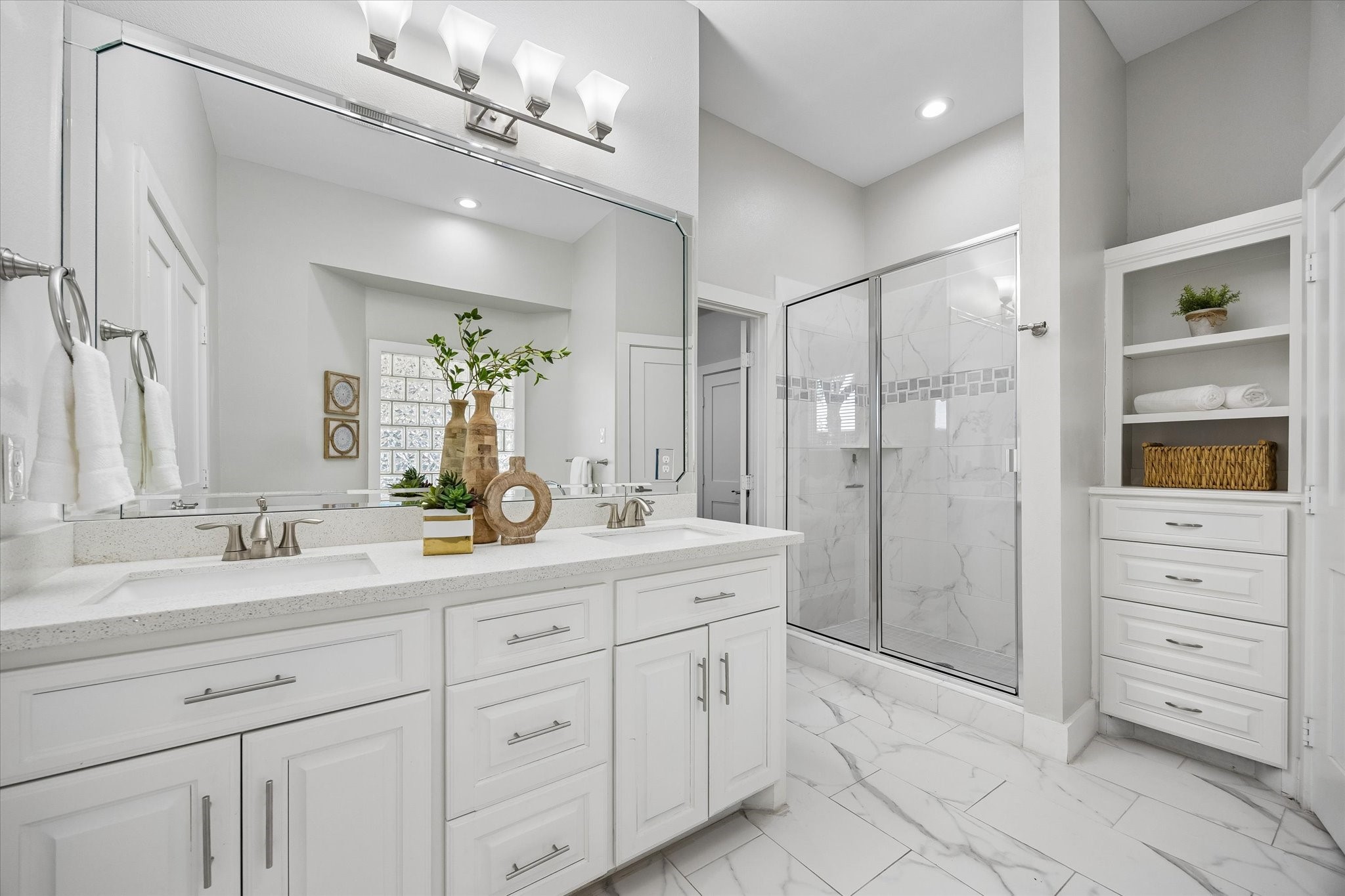 From busy mornings to relaxing evenings, this ensuite adds a little luxury to everyday life. Dual sinks, custom built-ins, a spacious walk-in shower and elegant finishes make it as practical as it is beautiful.