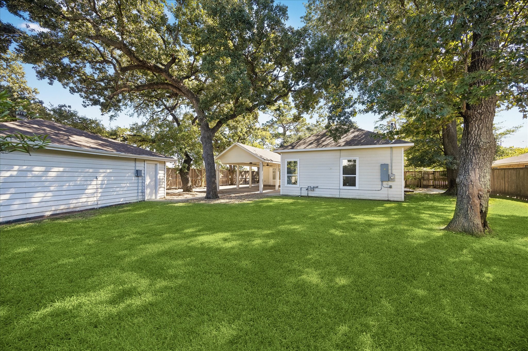 What a wonderful place to enjoy the outdoors. This spacious backyard offers a beautiful stretch of green lawn, mature shade trees and plenty of room for backyard games, weekend cookouts or simply relaxing in the shade of towering trees.