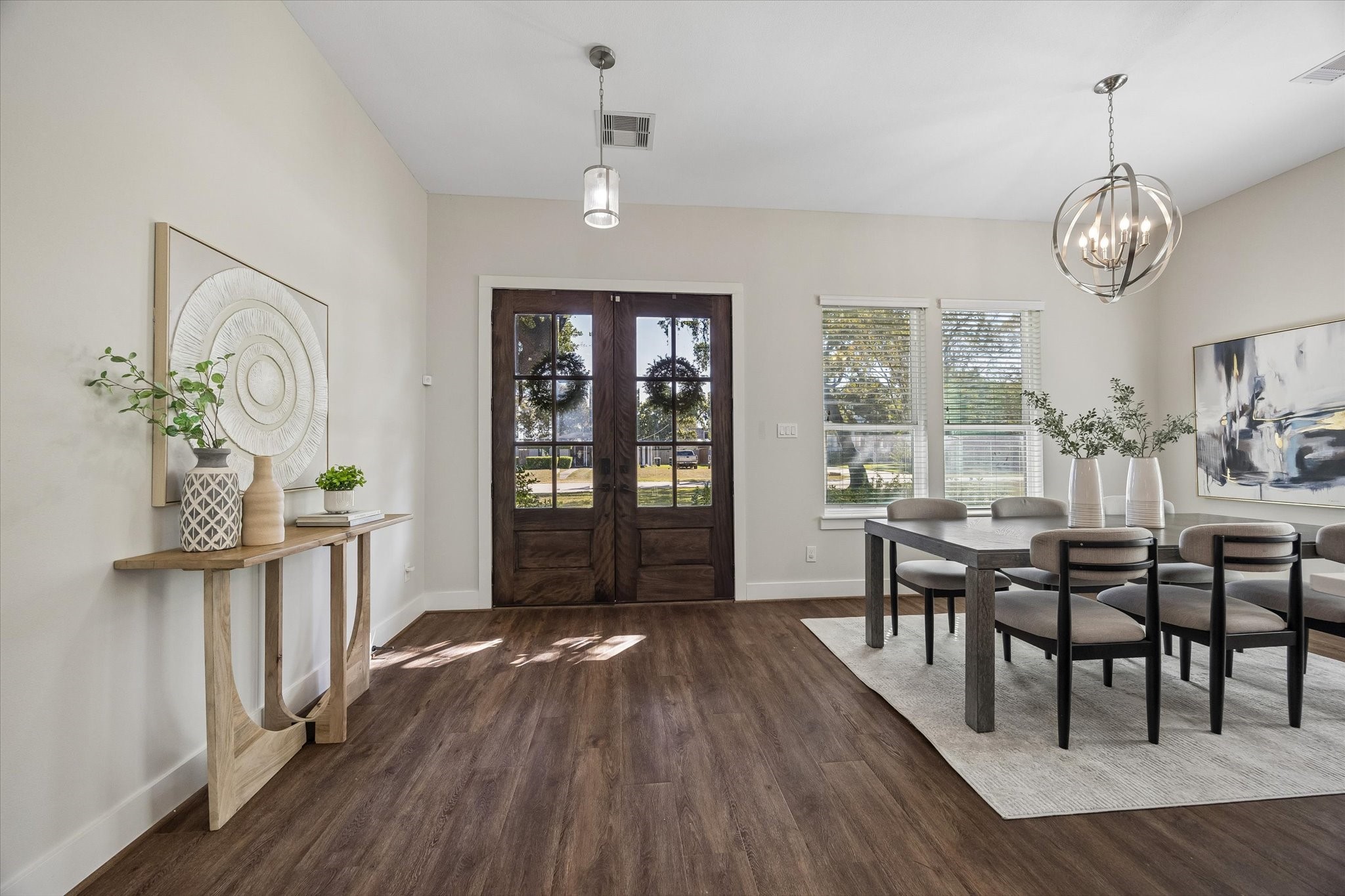 Welcome home! Beautiful double entry doors open to bright, inviting interiors with 10' ceilings, fresh neutral finishes, stylish lighting and updated luxury vinyl tile flooring.
