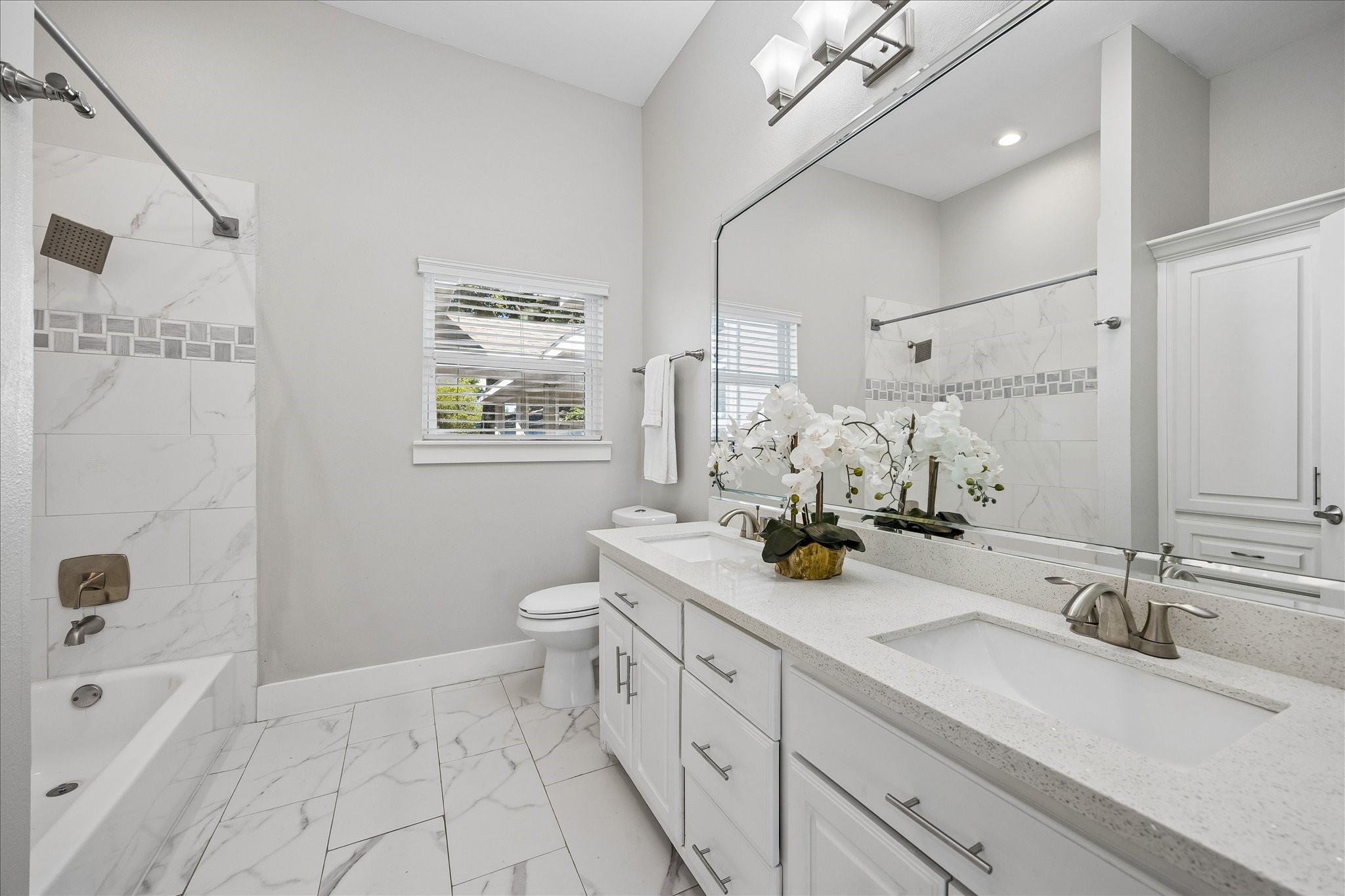 With three full bathrooms, there's room for everyone to get ready. This spacious hall bathroom features dual sinks, plenty of counter space and storage plus a tub and shower combination, all wrapped up in stylish neutral finishes.