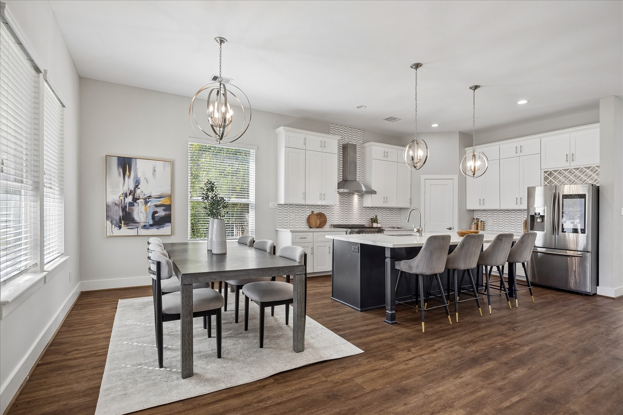 Good food and great company go hand in hand! The dining area opens to the spacious island kitchen, making it easy to cook, catch up and spend time together. Large windows, beautiful lighting and updated luxury vinyl tile flooring add to the charm.