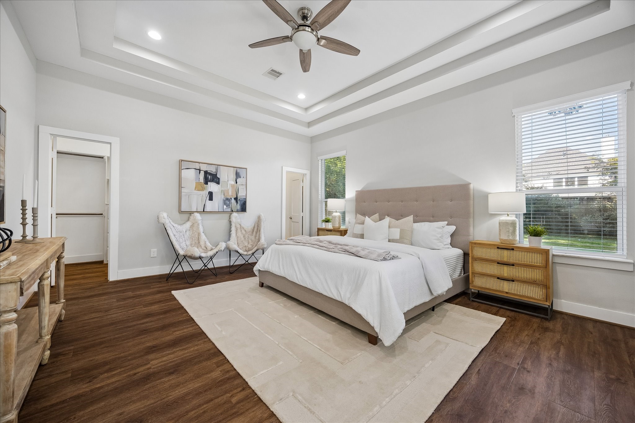 Why settle for one primary suite when you can have two? This spacious bedroom offers the flexibility of a second primary or luxurious guest retreat, complete with a beautiful triple tray ceiling, updated luxury vinyl tile flooring, private ensuite and custom walk-in closet. Perfect for extended family, long-term guests or multigenerational living.