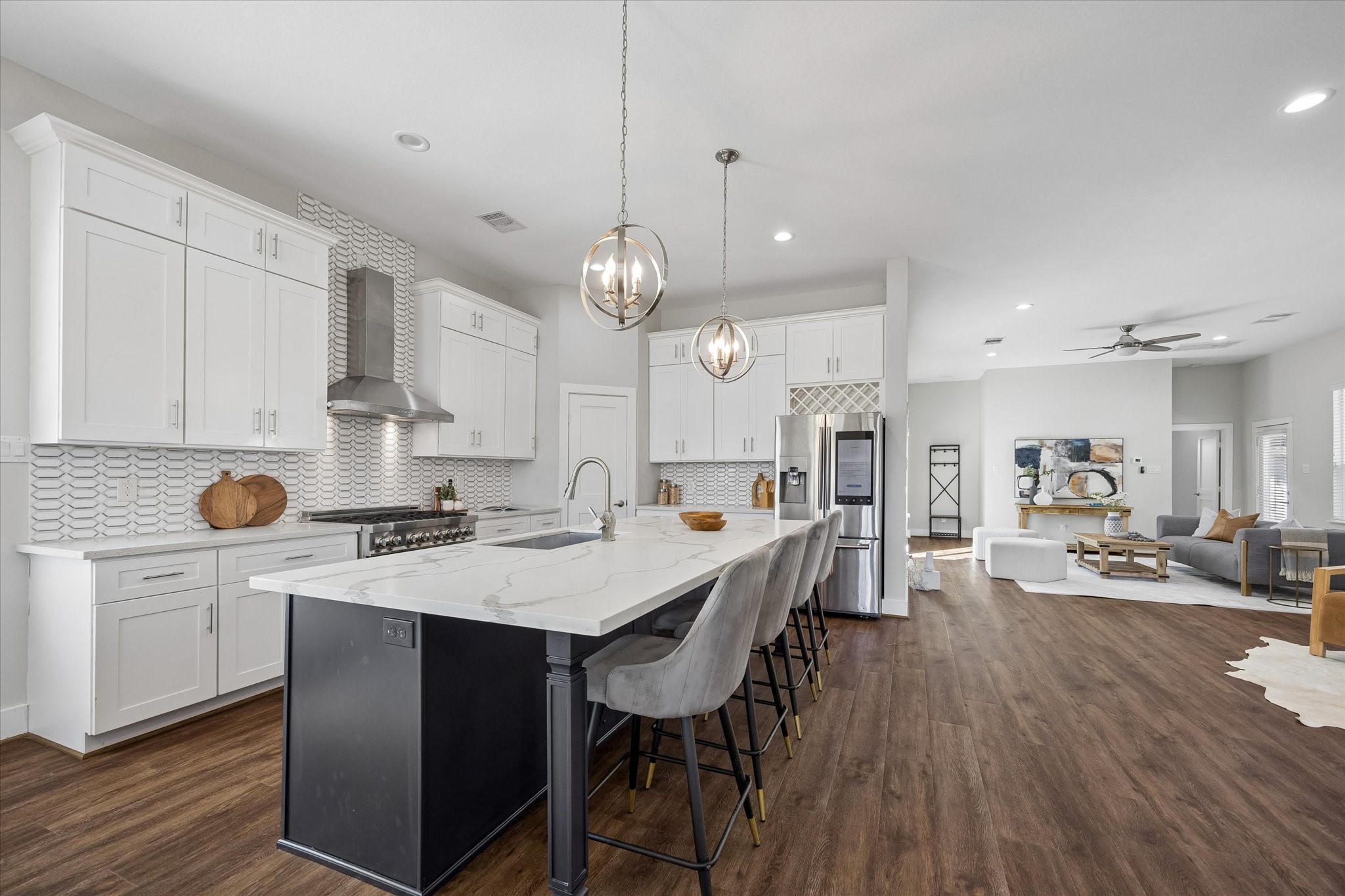 Love an open floor plan? The kitchen, living area, den and dining room flow together beautifully, with room to cook, entertain or simply relax while keeping everyone connected. Quartz countertops, abundant cabinetry and a spacious island make it all work with ease.