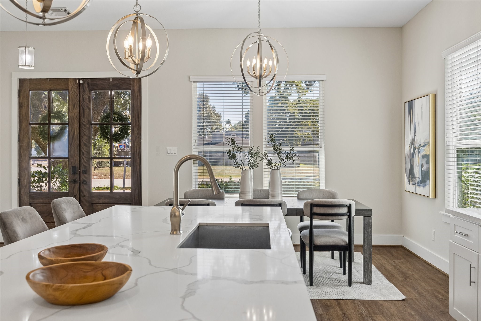 From kitchen to table in a snap! The oversized island offers plenty of space to prepare meals, serve snacks or catch up over coffee. With stylish overhead lighting and plenty of natural light, this inviting space is perfect for everything from casual meals to more formal gatherings.