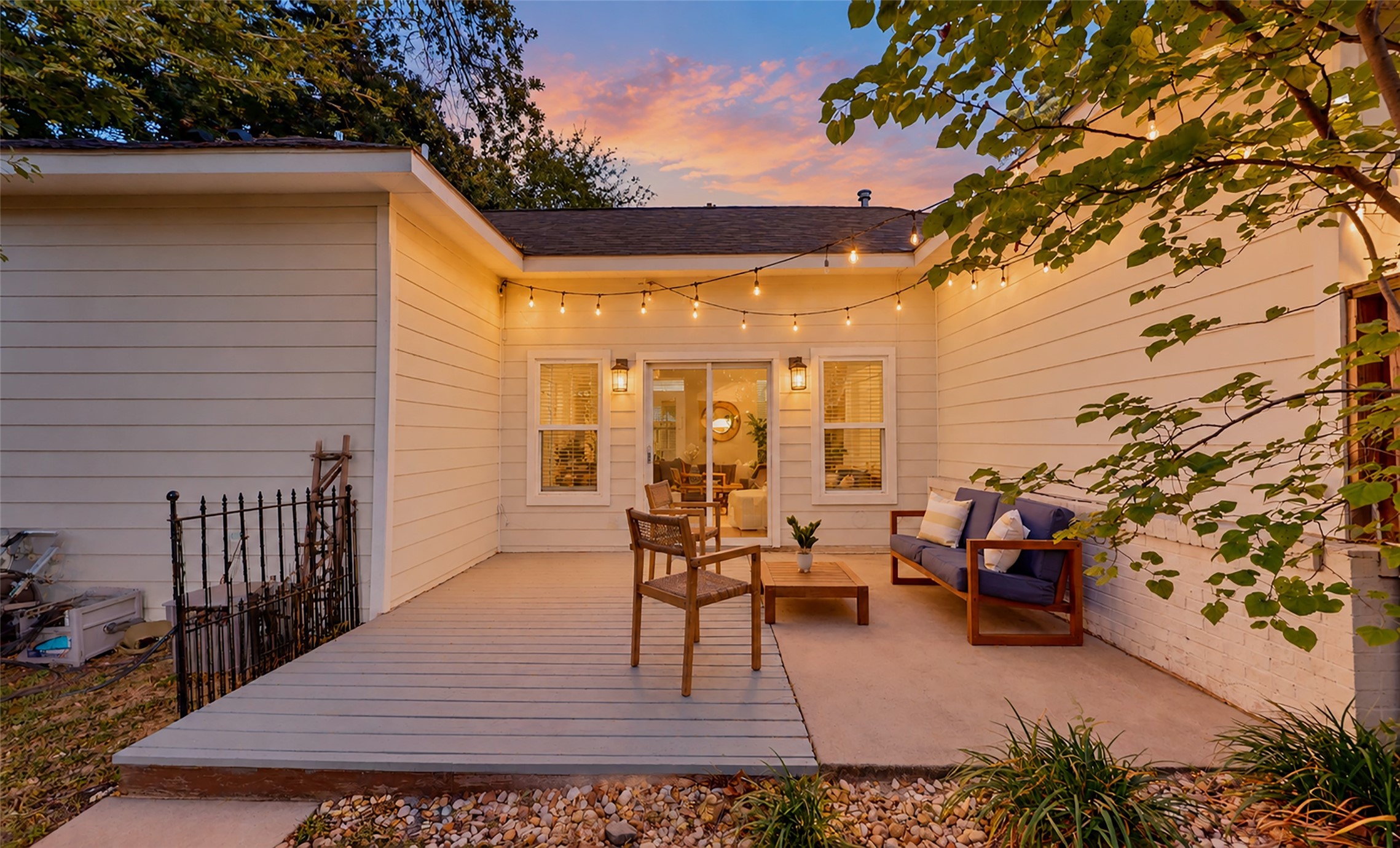 As dusk settles in, this charming private patio becomes the perfect place to unwind after a long day. Whether you're sharing a glass of wine with friends or enjoying a quiet evening under the stars, you'll love having this cozy outdoor retreat just steps from home.