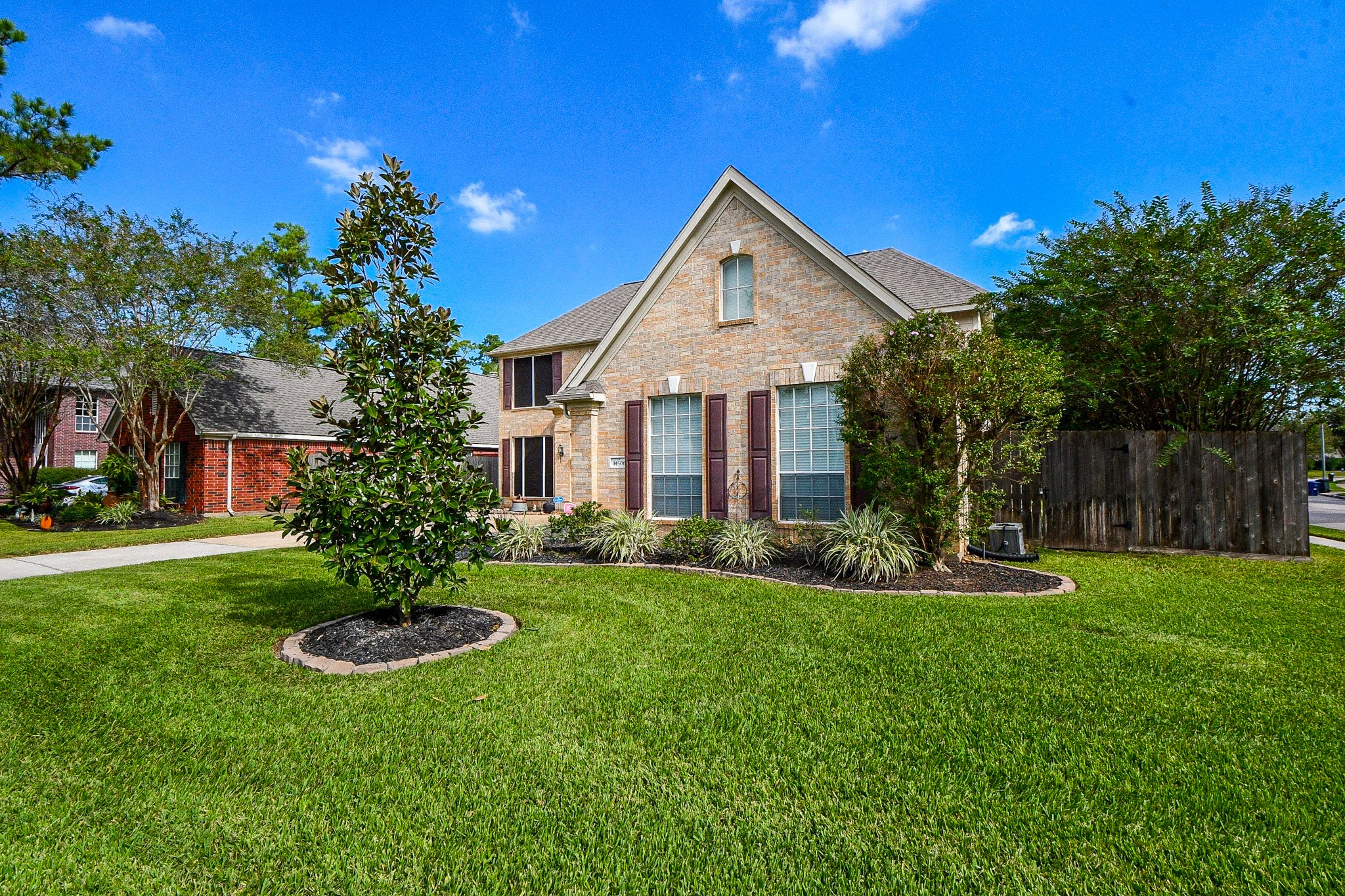 Set on a spacious corner lot, this beautiful brick home offers a welcoming first impression with mature landscaping, an expansive front lawn, and timeless architectural charm.