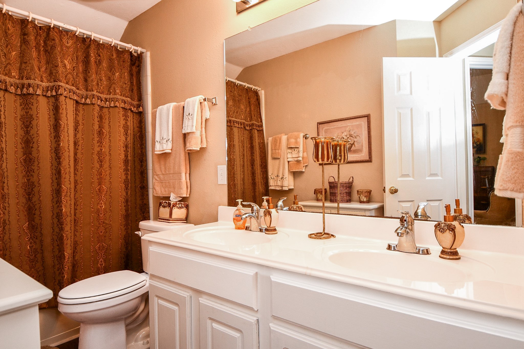 Busy mornings are a little easier with two sinks! This secondary bathroom features a spacious double vanity with generous counter space and a tub/shower combination, offering everyday convenience.