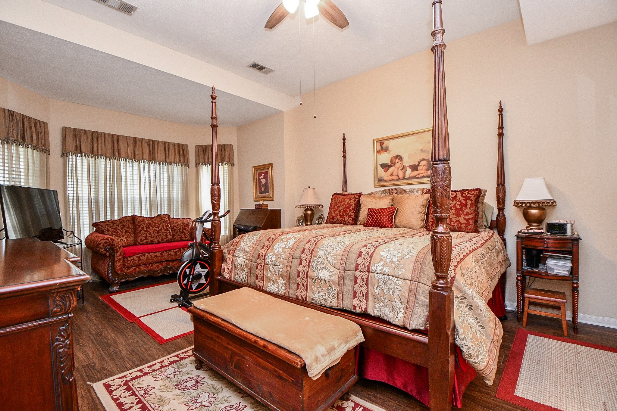 Your bedroom should be more than just a place to sleep. With generous proportions, a high ceiling, and a comfortable sitting area, this primary retreat offers room to unwind, read a favorite book, or enjoy a little quiet time at the end of the day.