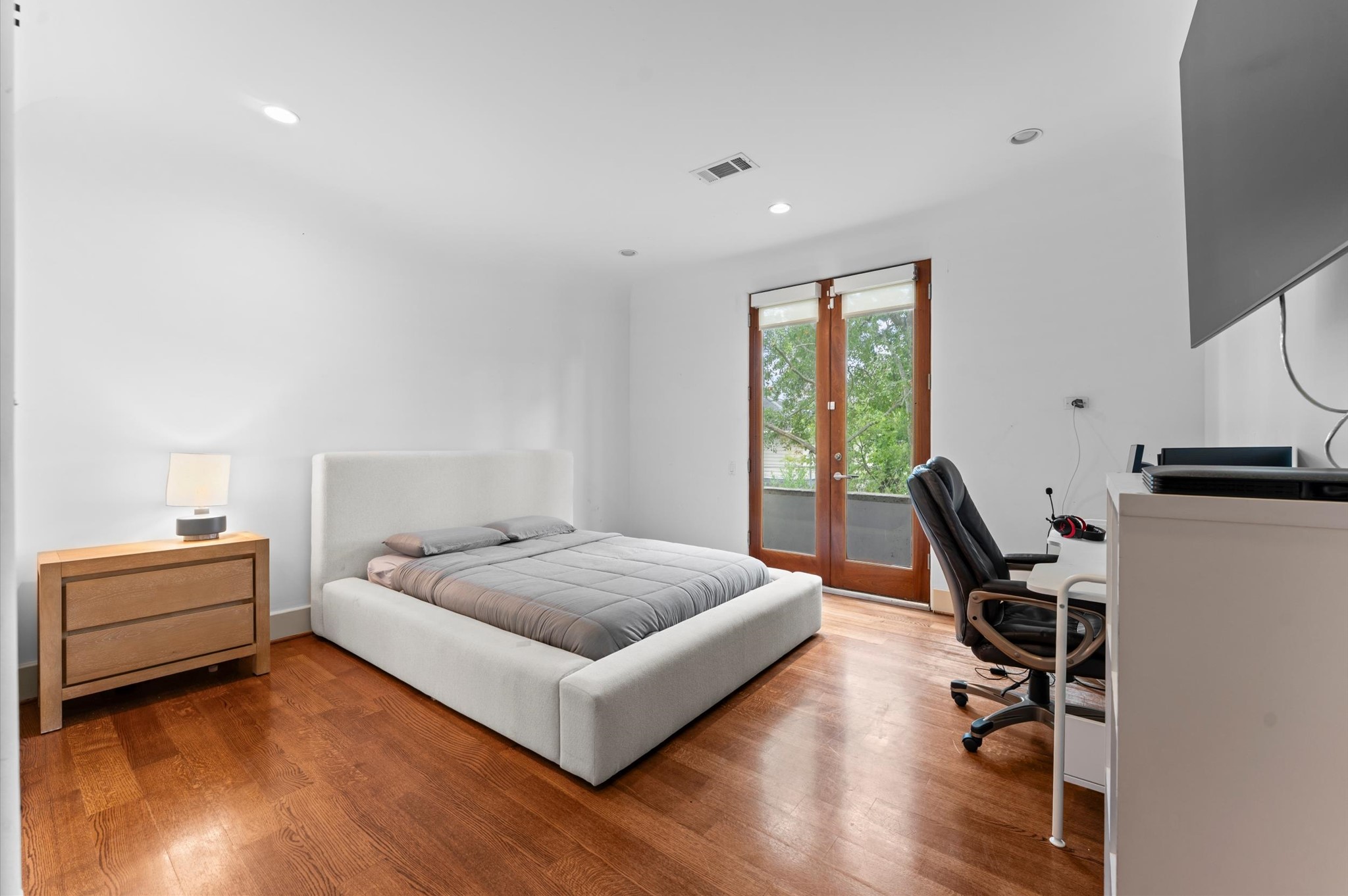An inviting bedroom retreat with a private en suite bathroom and generous custom closet storage.