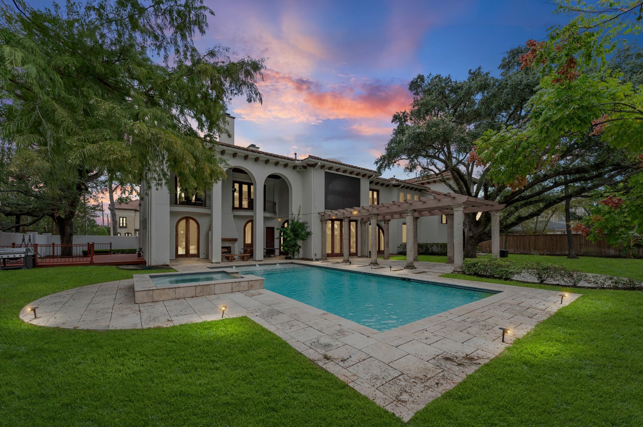 Experience the beauty of timeless Modern Spanish architecture, where expansive travertine pool decking, a custom pool and raised spa, and a grand pergola create an extraordinary outdoor retreat. Framed by mature trees and elegant architectural details, this private oasis invites you to relax, entertain, and enjoy luxury living at its finest.