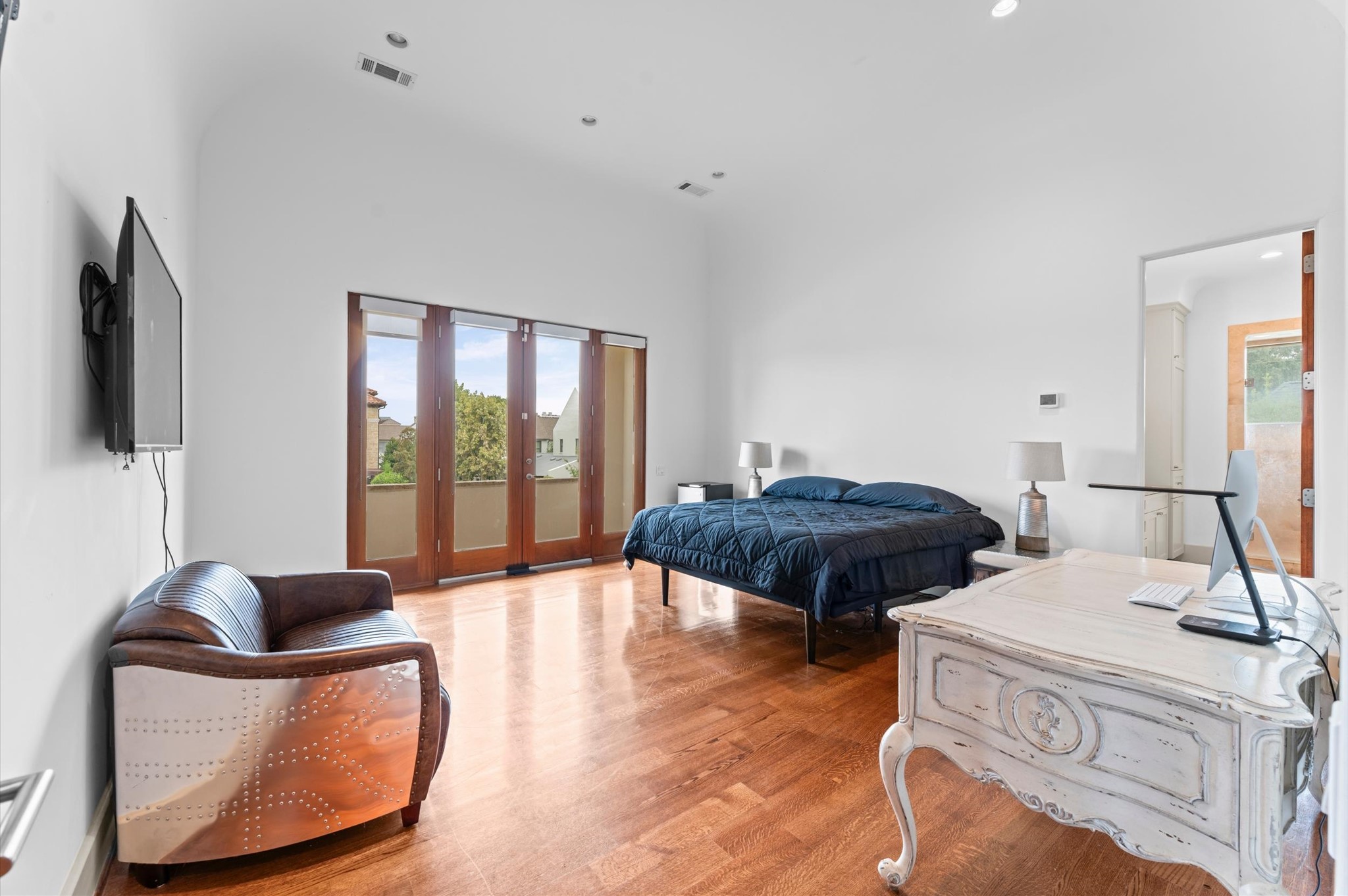 This secondary bedroom offers its own en suite bath and custom walk-in closet, combining privacy, storage, and everyday comfort.