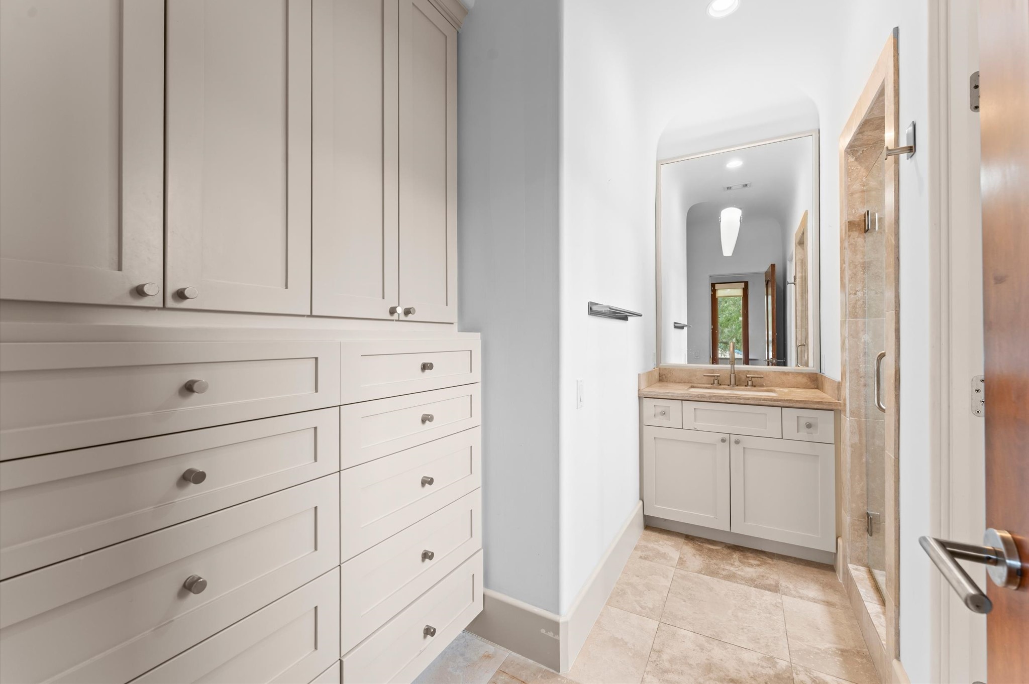 An additional en suite bath provides a dedicated bathing space for another secondary bedroom, supporting the home's well-appointed suite-style layout.