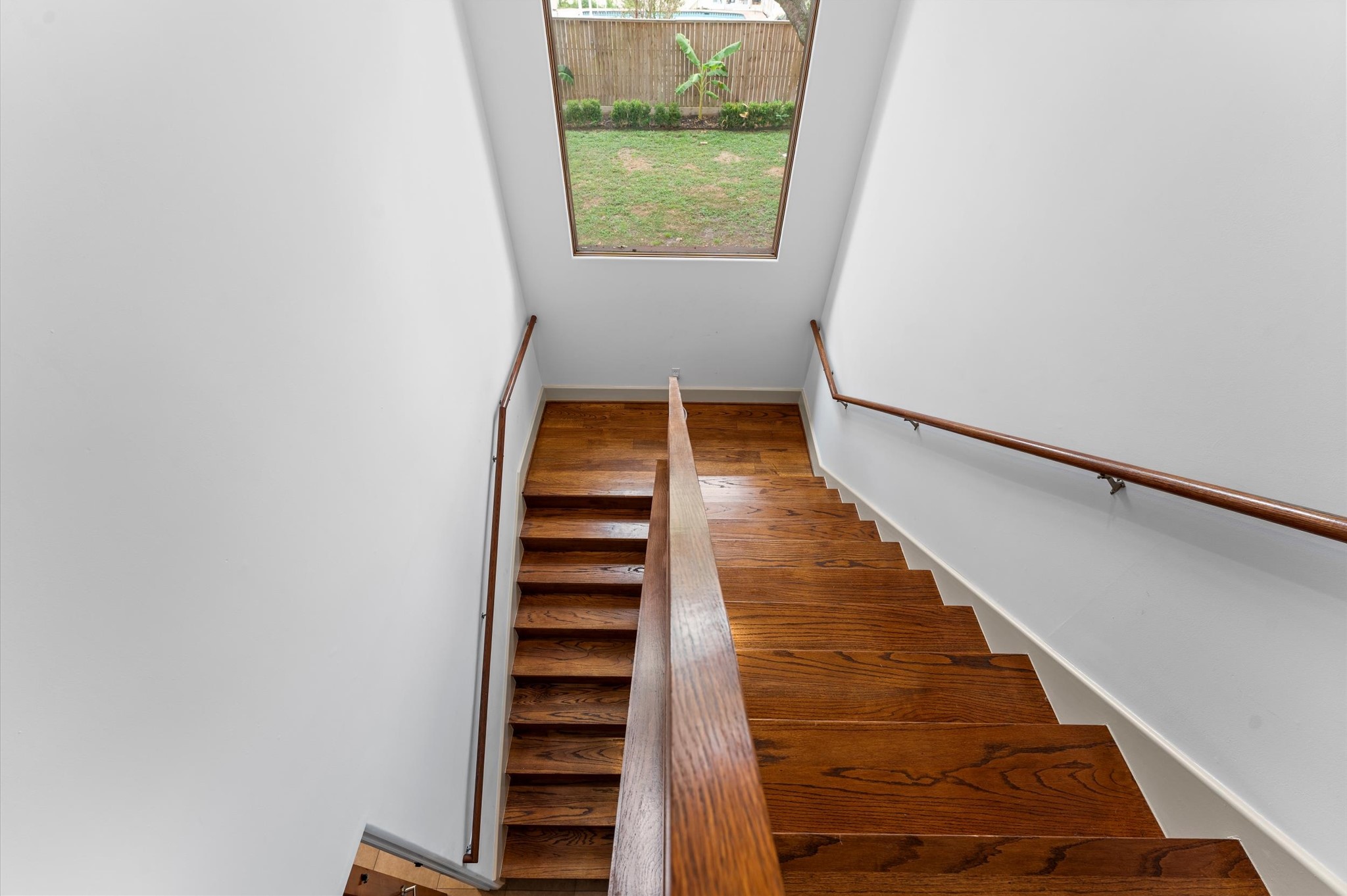 A secondary staircase accessed from the mudroom provides convenient circulation to the upstairs bedroom areas, adding functionality to the home's thoughtful floor plan.