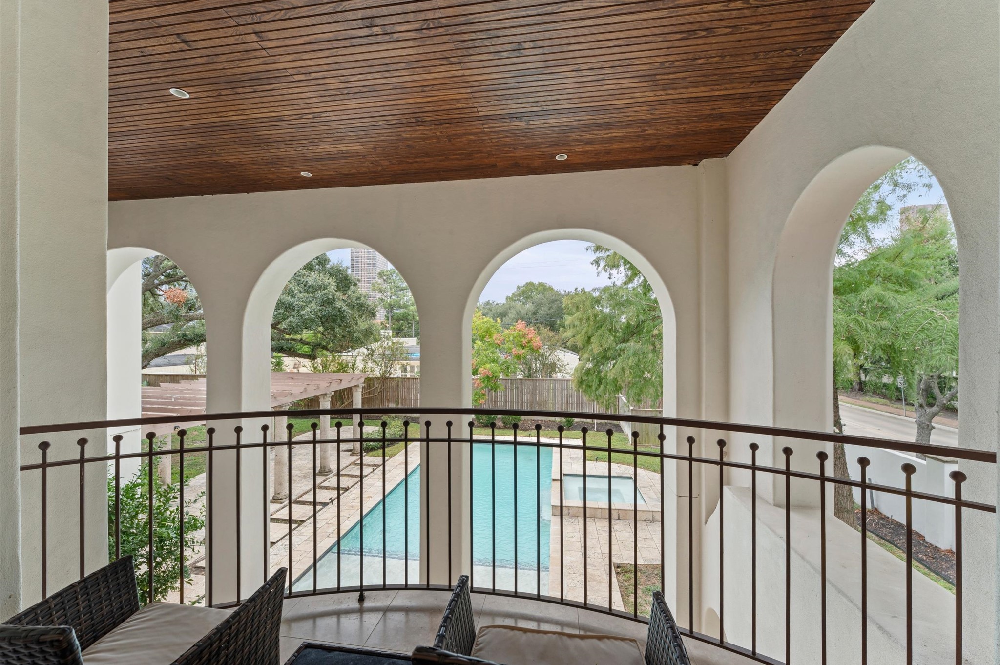 A private primary suite balcony offers an elevated outdoor retreat overlooking the estate grounds.